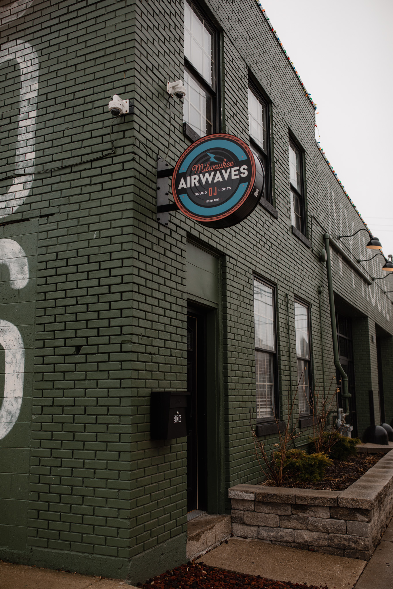 Milwaukee Airwaves DJ sound and lighting sign on the outside of the Ivy House building