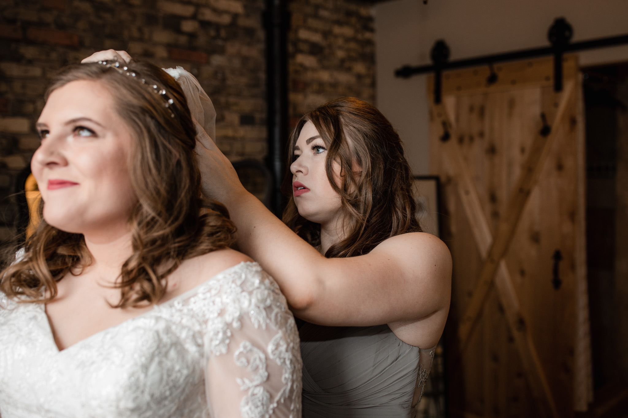 Maid of honor putting veil on bride - lavender bridesmaid dresses at Milwaukee's Ivy House