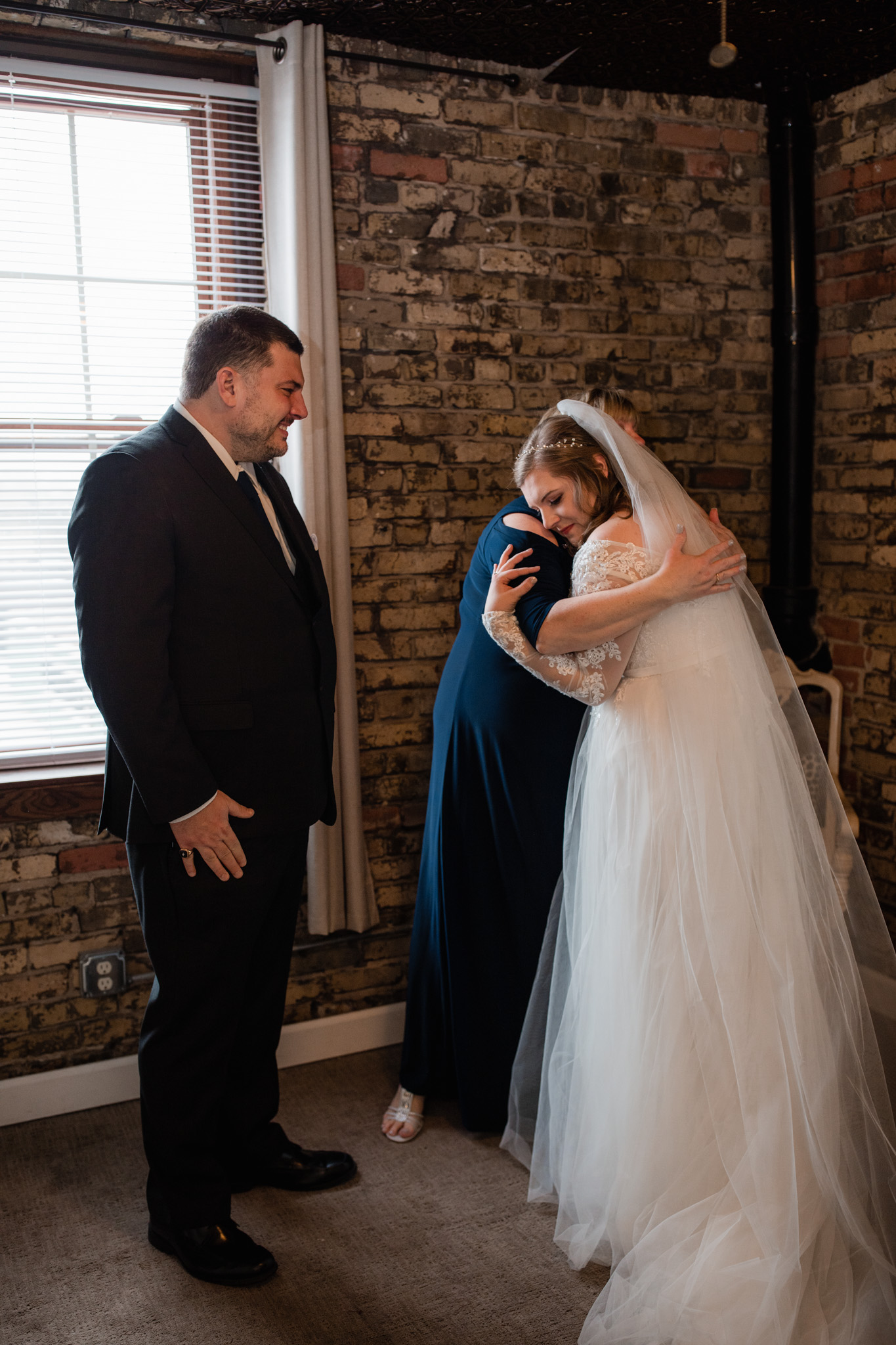 Mom hugging bride before her wedding day at the Ivy House - sentimental candid emotional wedding photography - milwaukee wi
