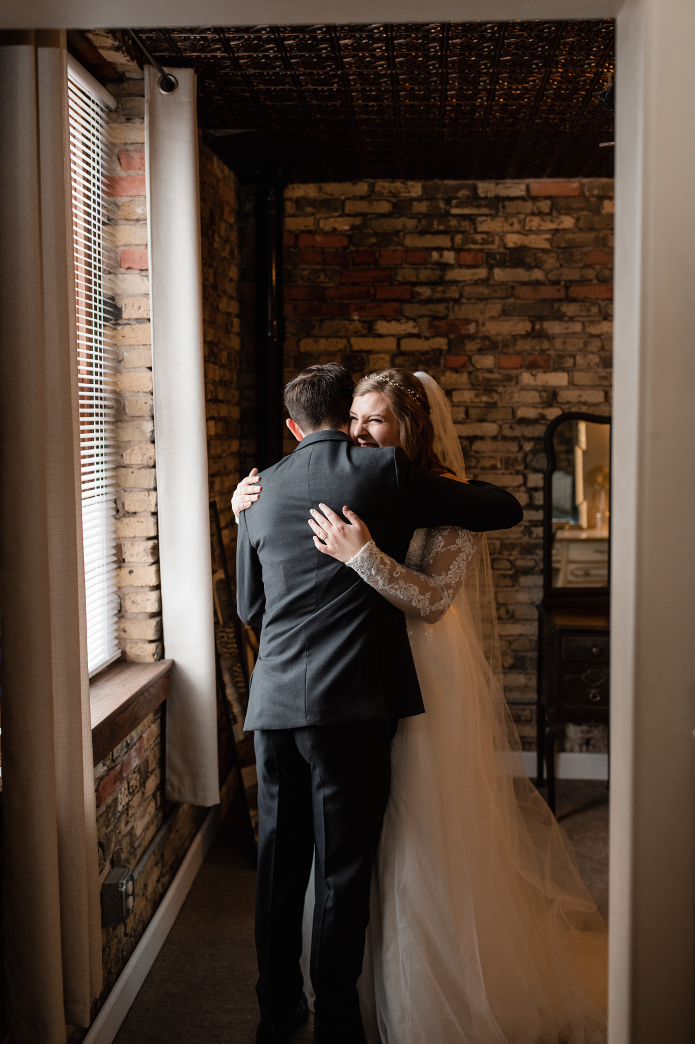 Giggly bride laughing during first look 