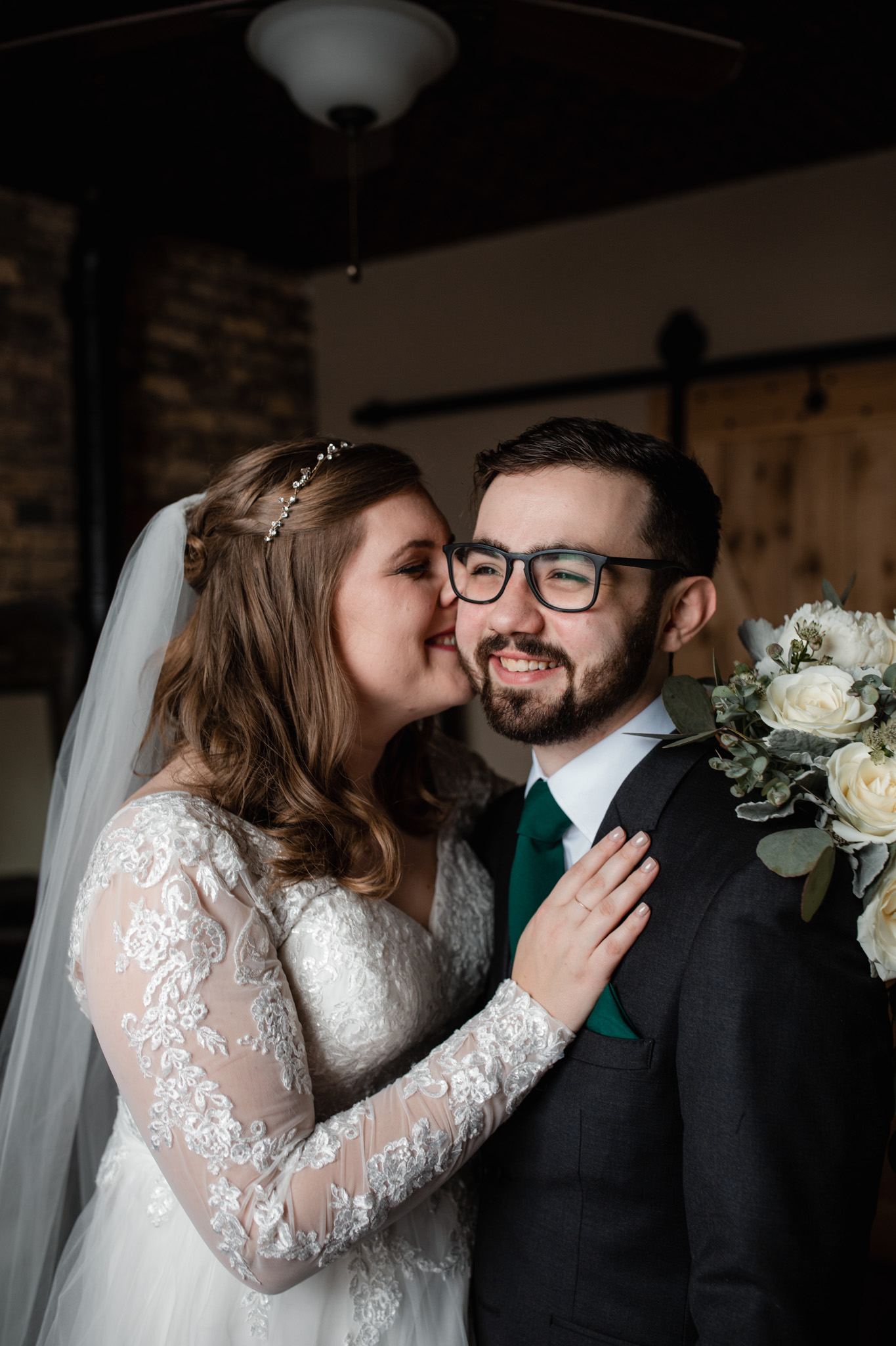 bride whispering in groom's ear