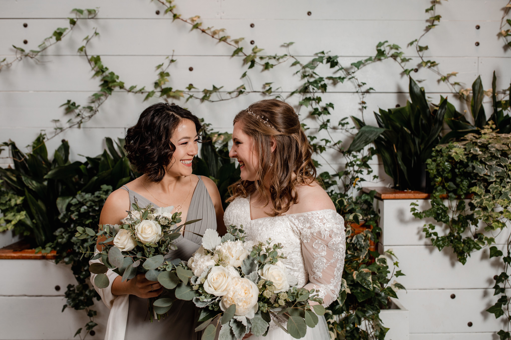 Bride and bridesmaid Ivy House greenery wall milwaukee - lavender dress