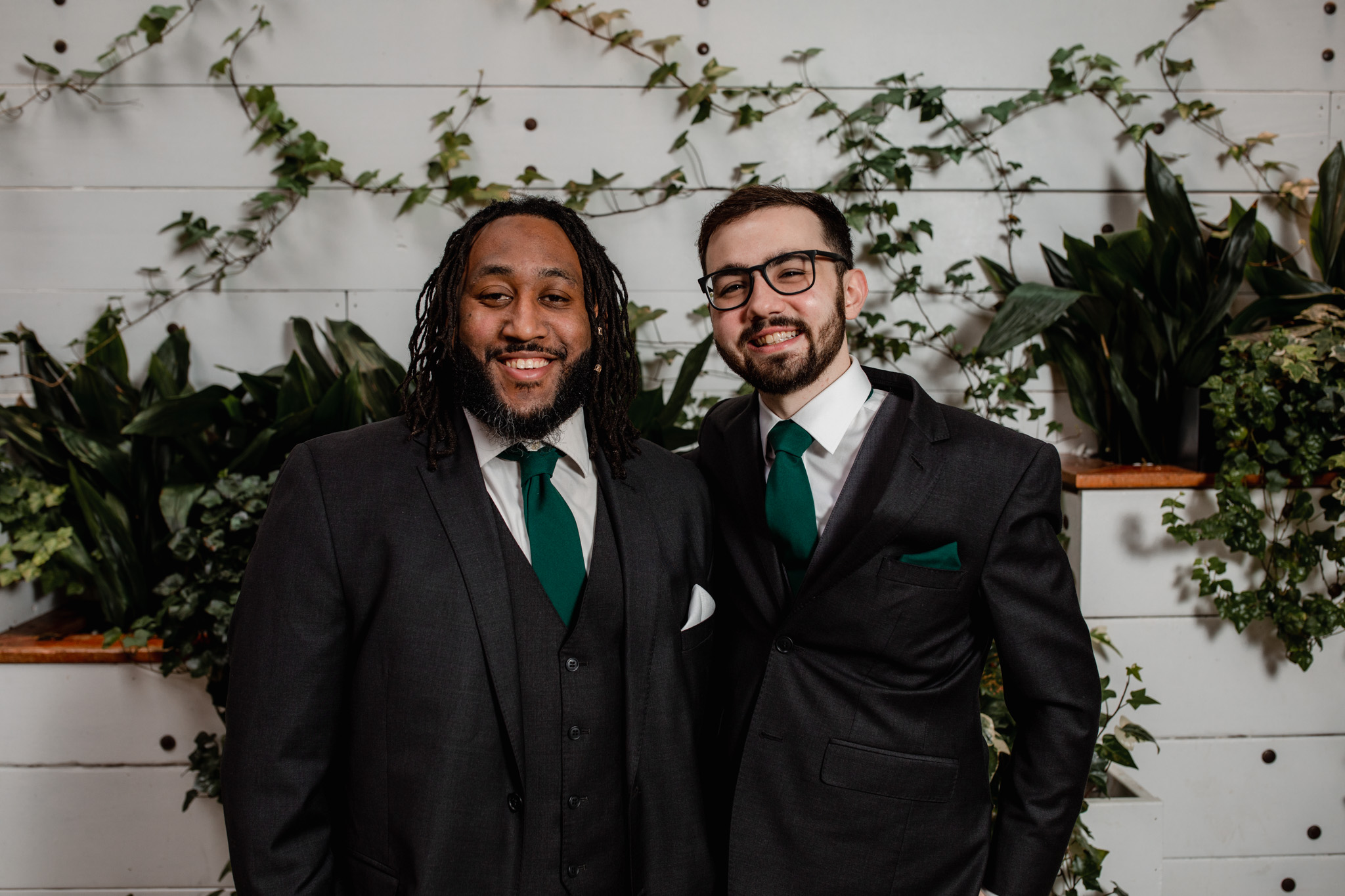 Groom and groomsmen ivy house greenery wall milwaukee - lavender dress