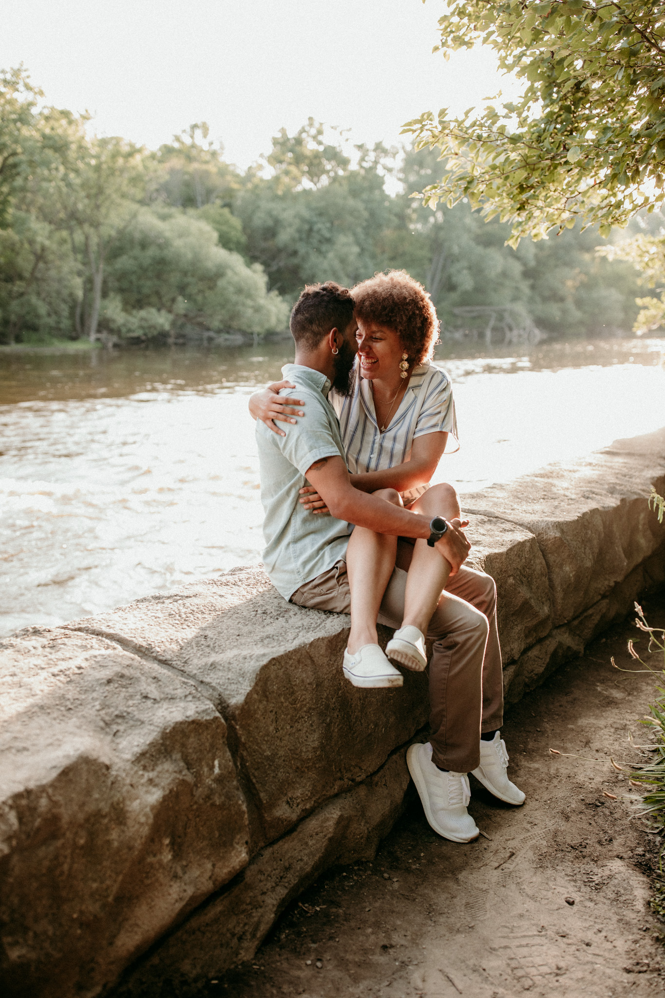 cute couple sitting on the Milwaukee River on an adventure date