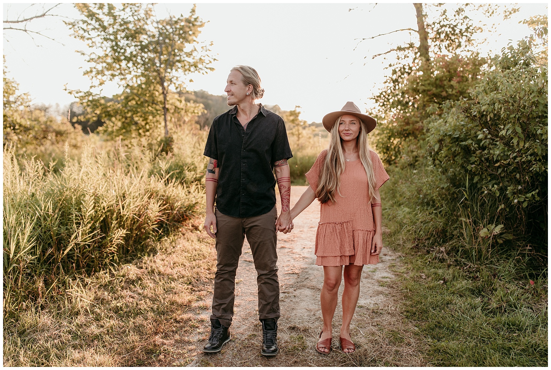 summery boho couple dancing in the prairie