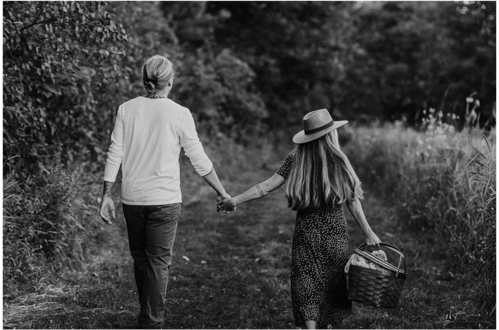 hipster boho couple holding hands in a wisconsin park