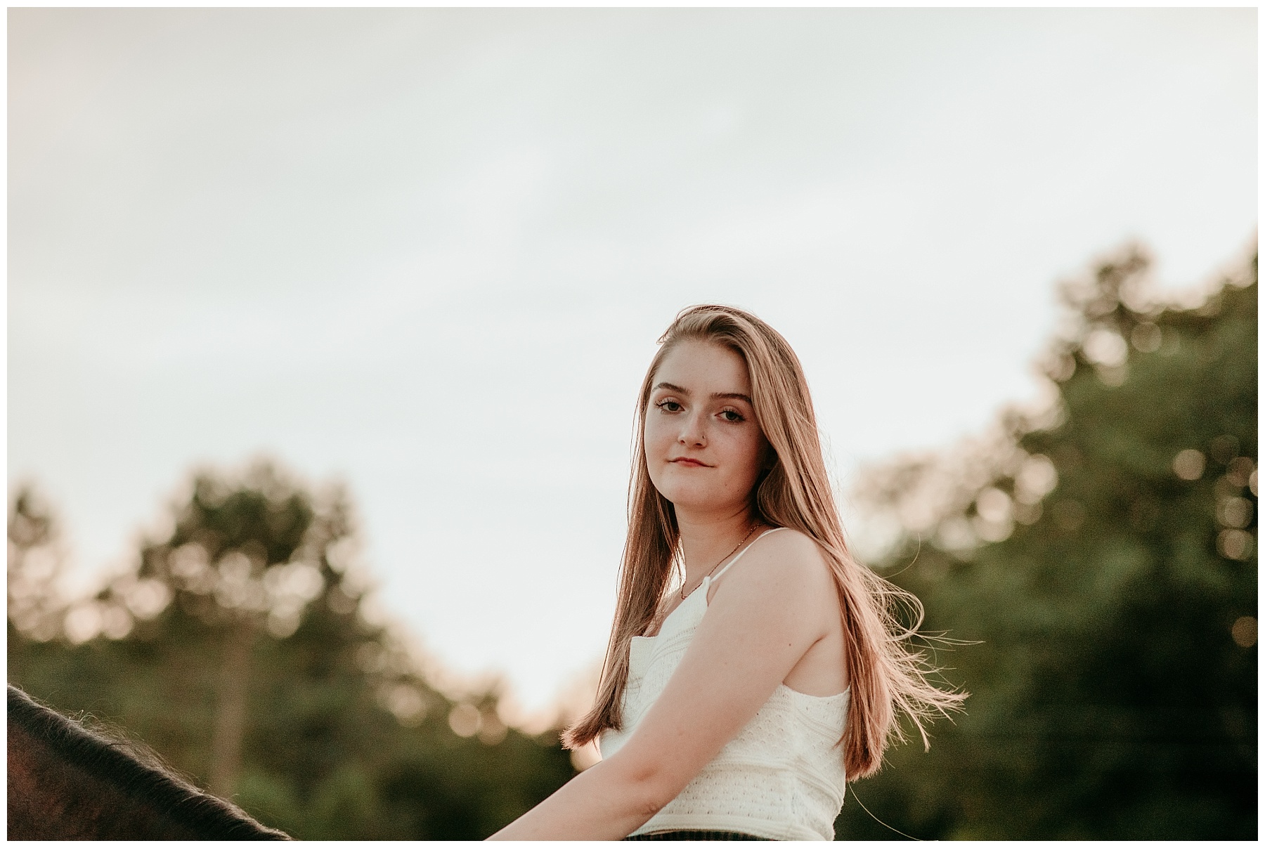 Senior girl riding a horse for her senior pictures at sunset in Cedarburg
