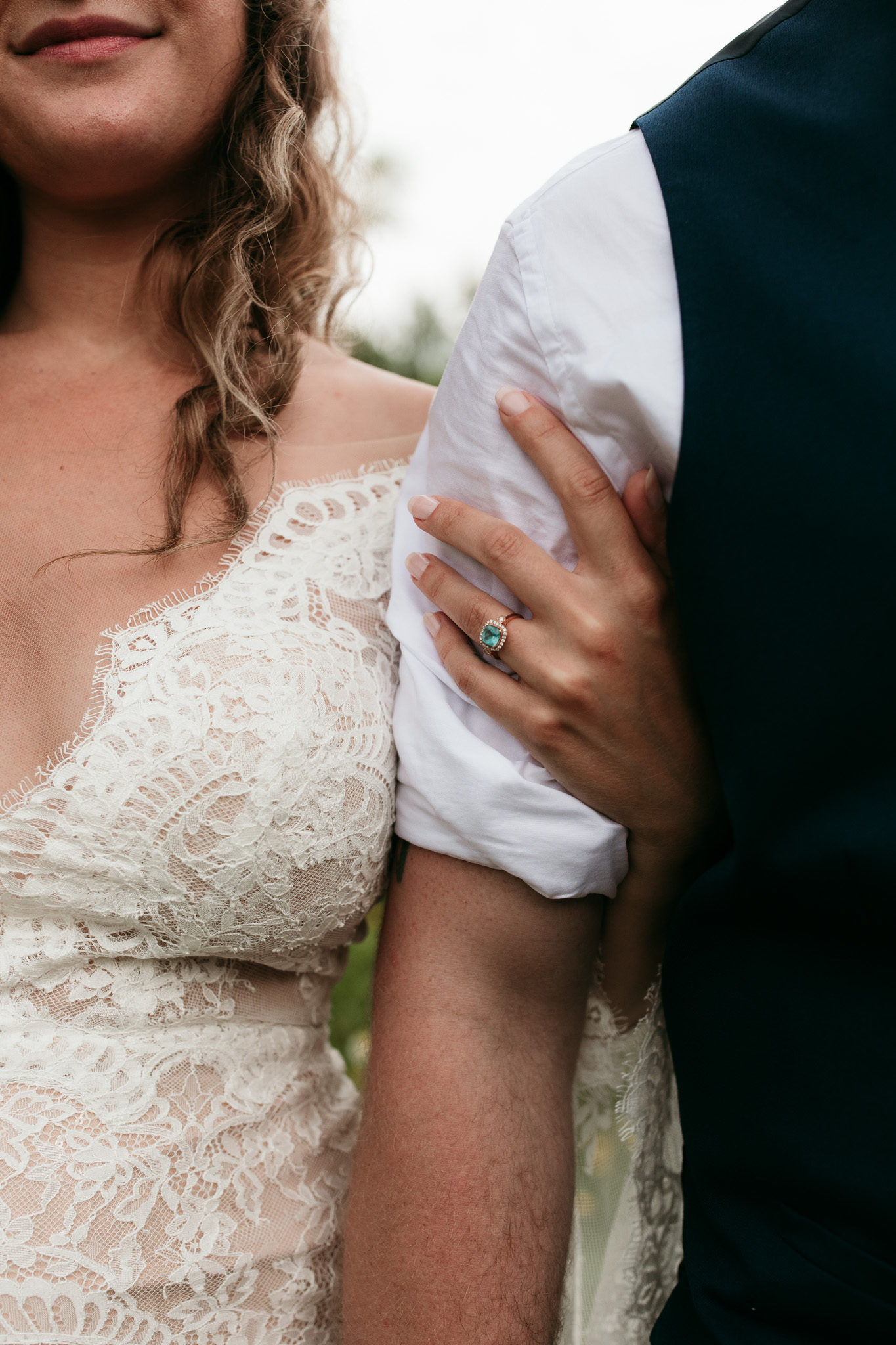 nontraditional blue wedding and engagement ring on brides hand with manicured nails