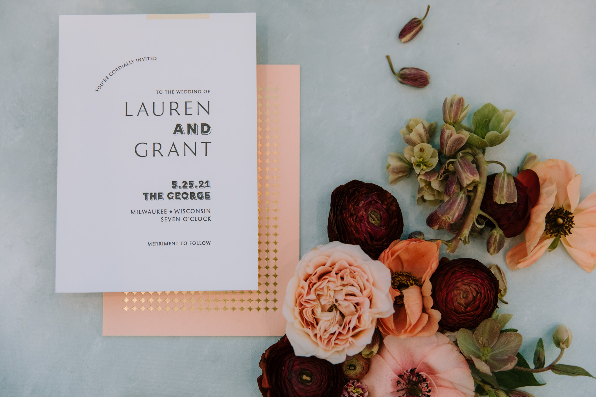 Wedding invitation George Milwaukee surrounded by flowers - photography flatlay