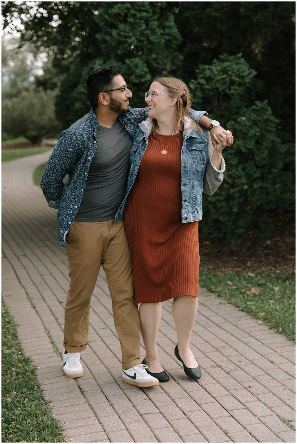 Couple walking along brick path for summer engagement pictures