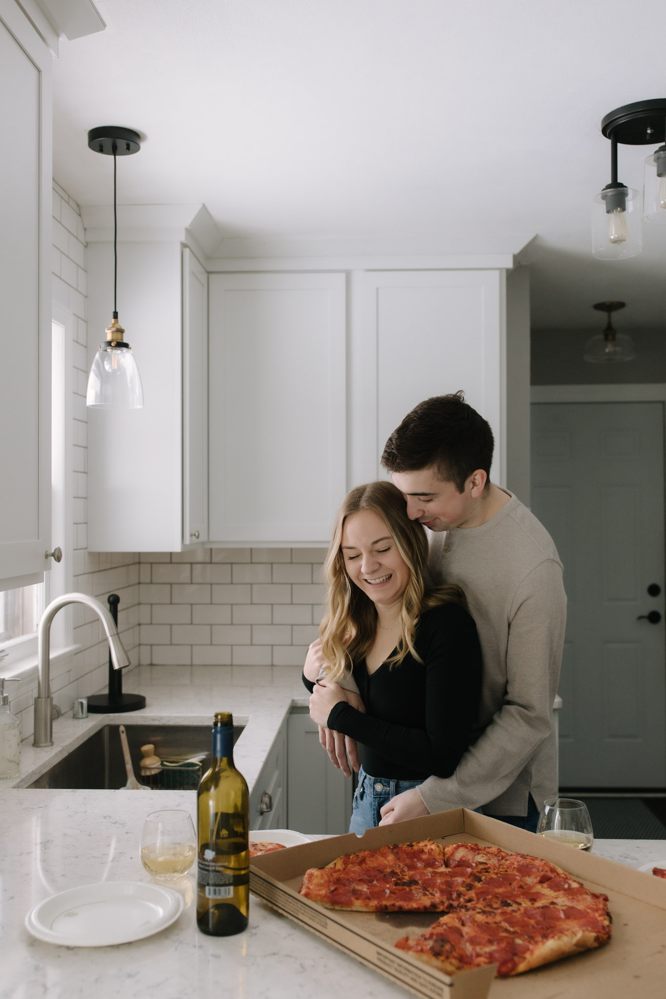 New home photoshoot with pizza and wine in the kitchen