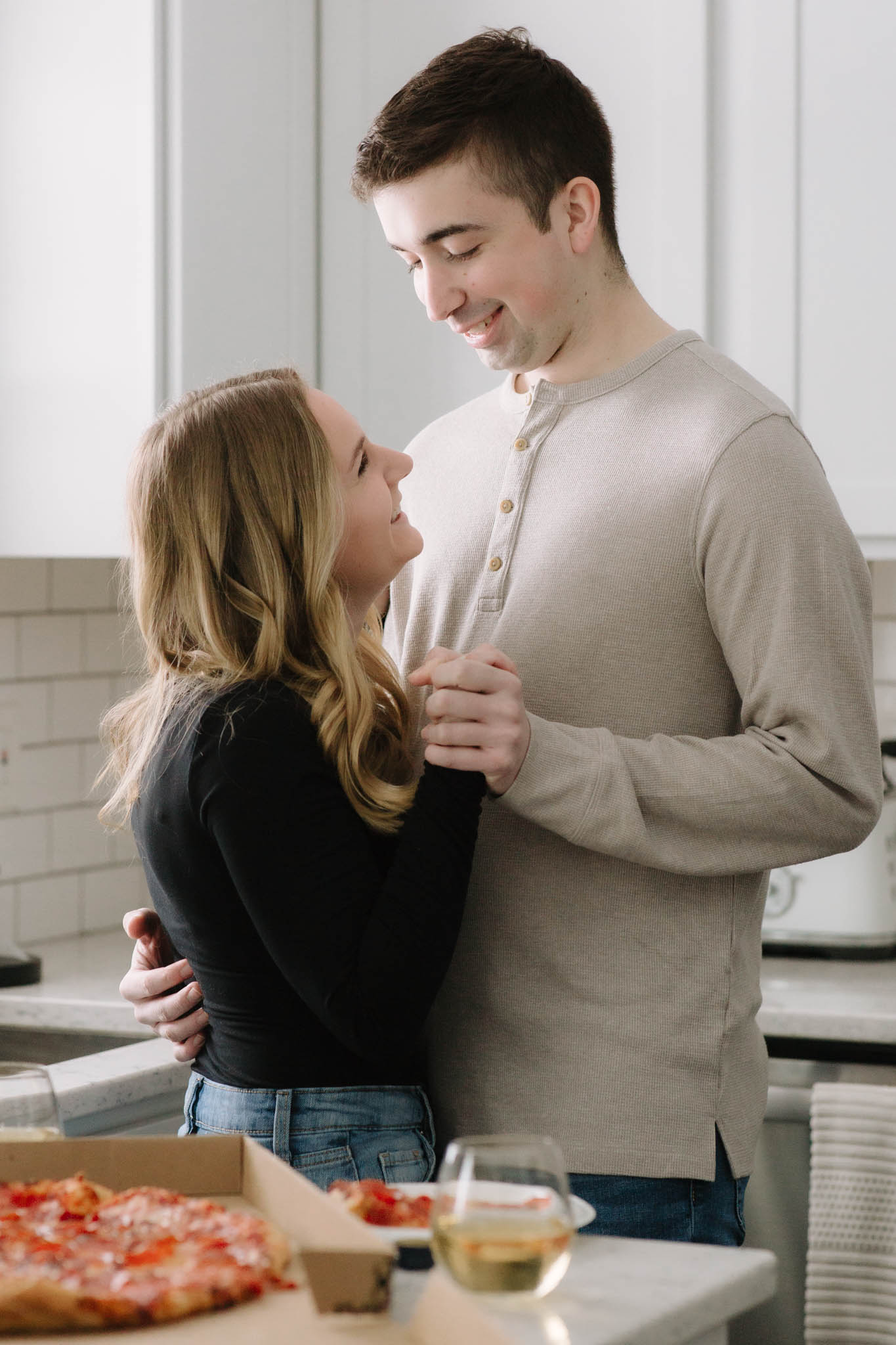 Couple dancing in the kitchen of their new home for a photoshoot