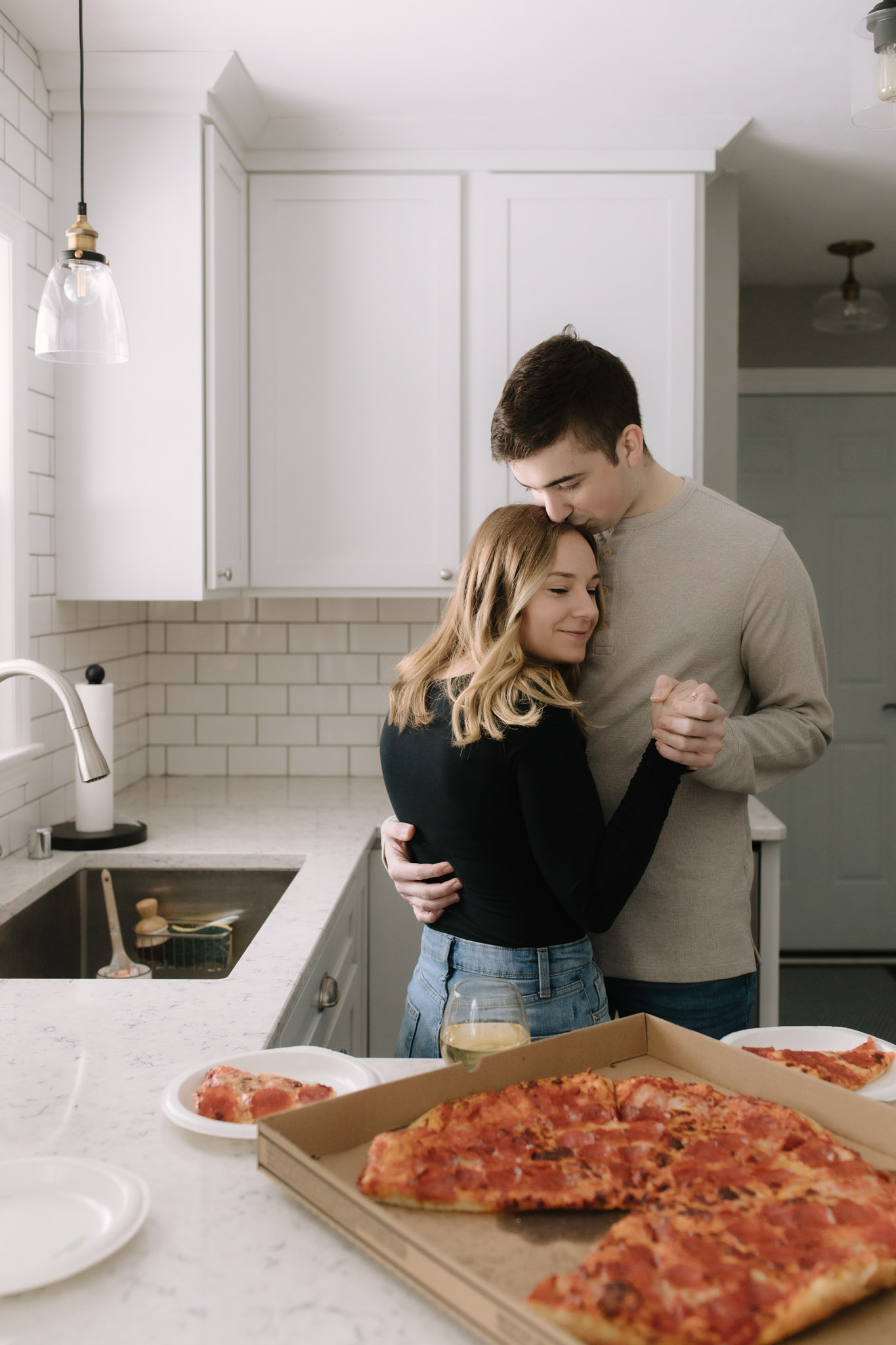 Sweet couple moving into new home eating pizza
