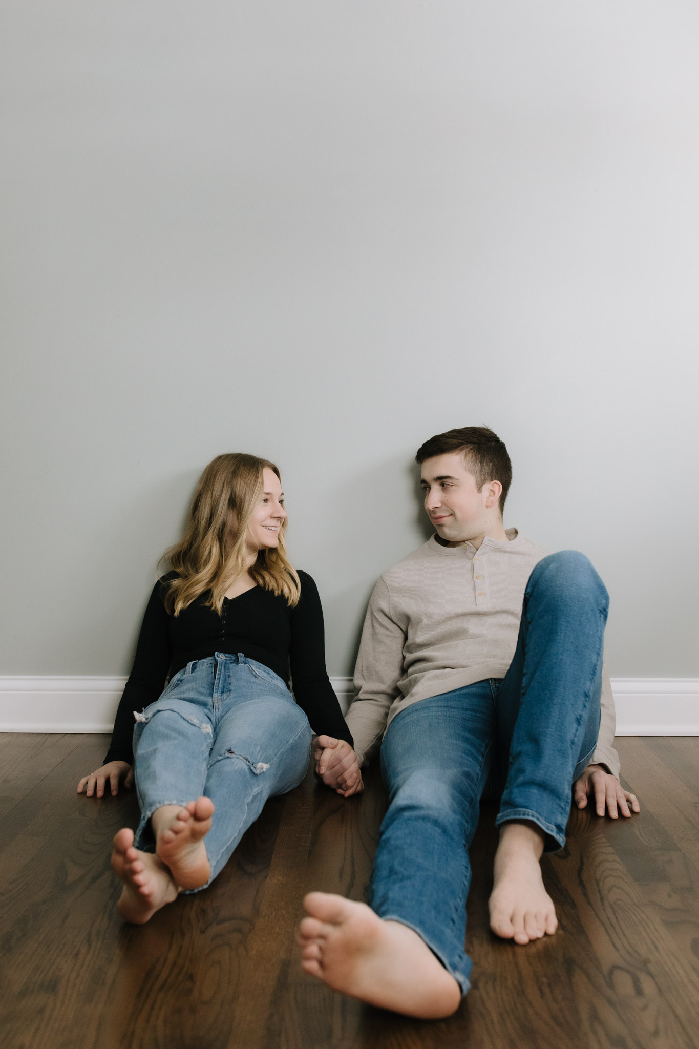 Couple sitting on the floor of their empty house