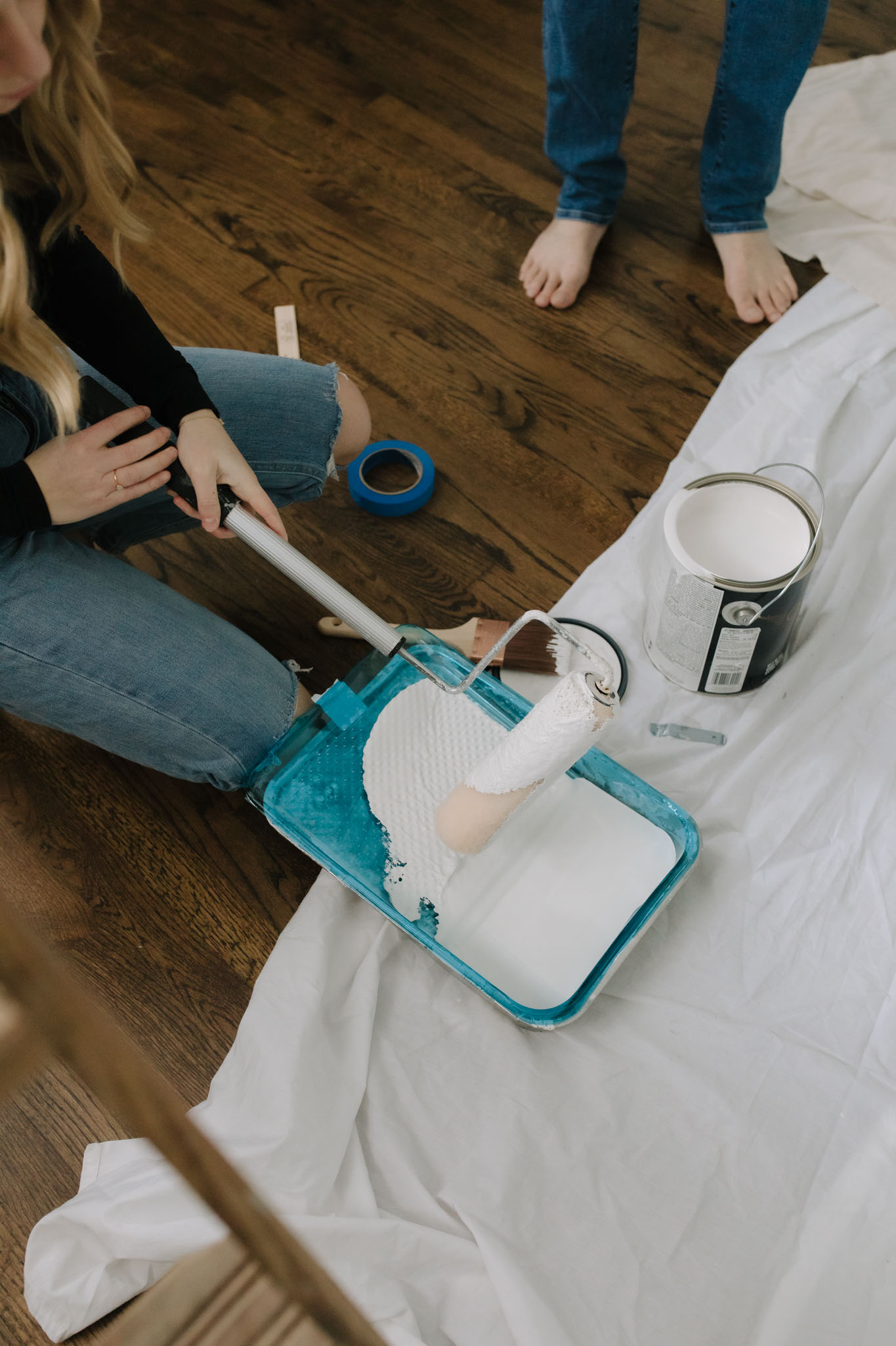 Couple painting their new house white
