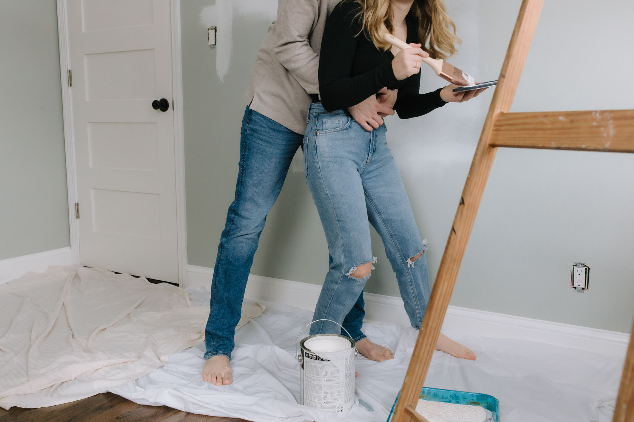 couple play fighting with paint