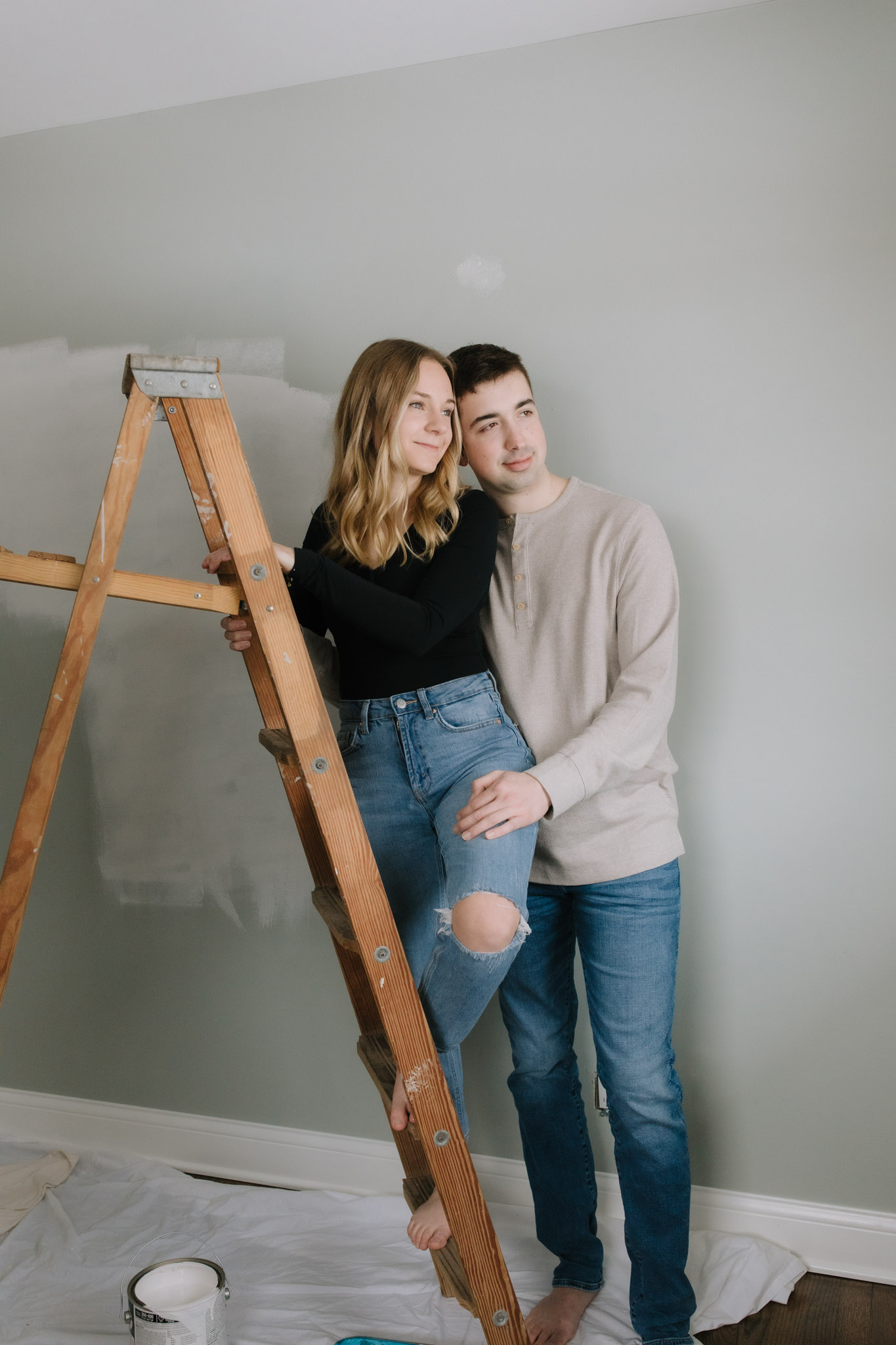 Couple standing on ladder for engagement pictures - creative engagement couples portraits