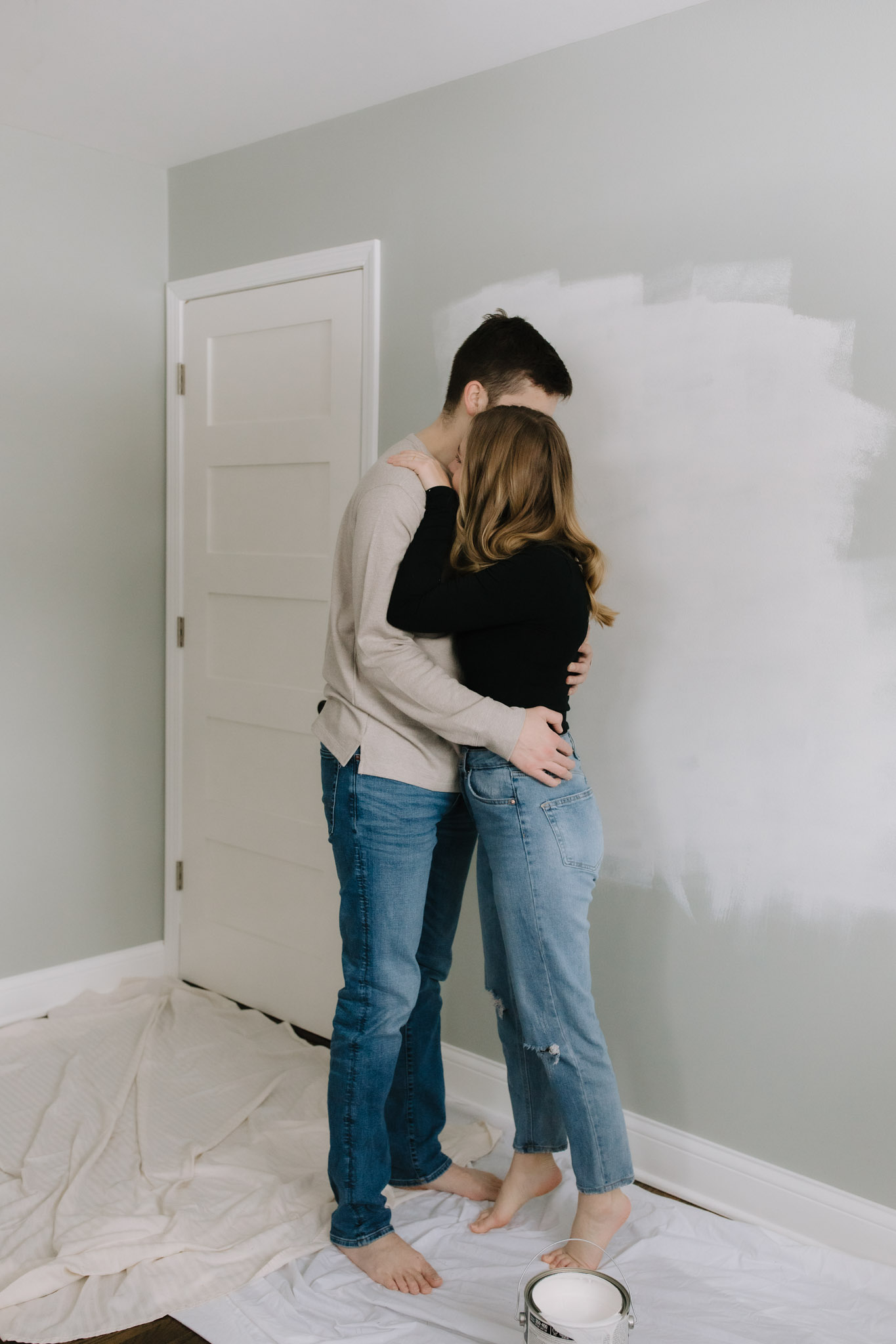 Cute Port Washington Wisconsin couple painting their newly purchased house for a new home photo session