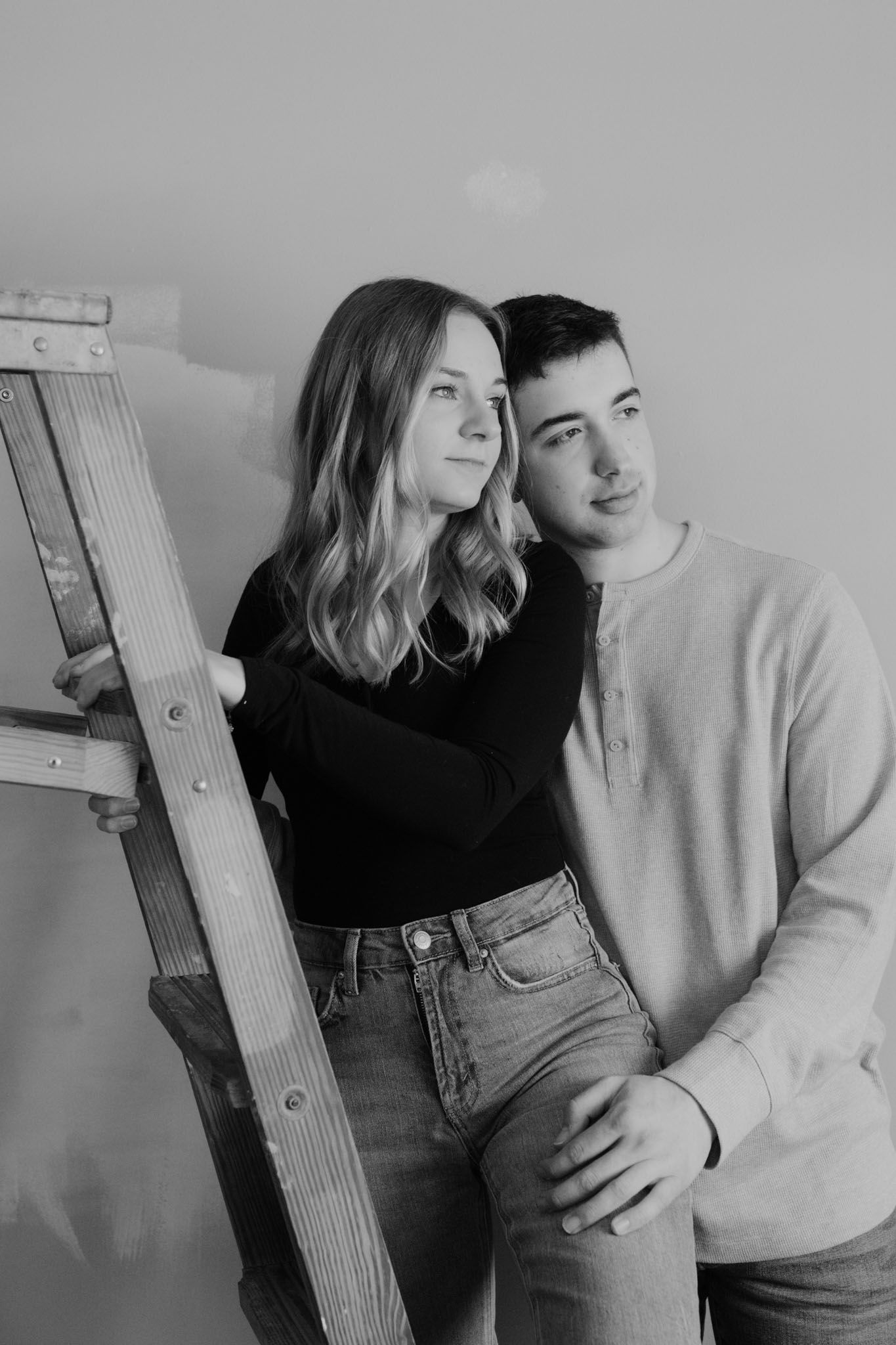Couple standing on ladder for engagement pictures - creative engagement couples portraits