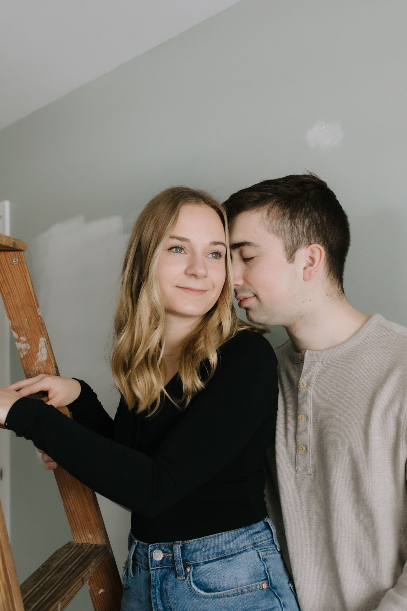 Couple standing on ladder for engagement pictures - creative engagement couples portraits