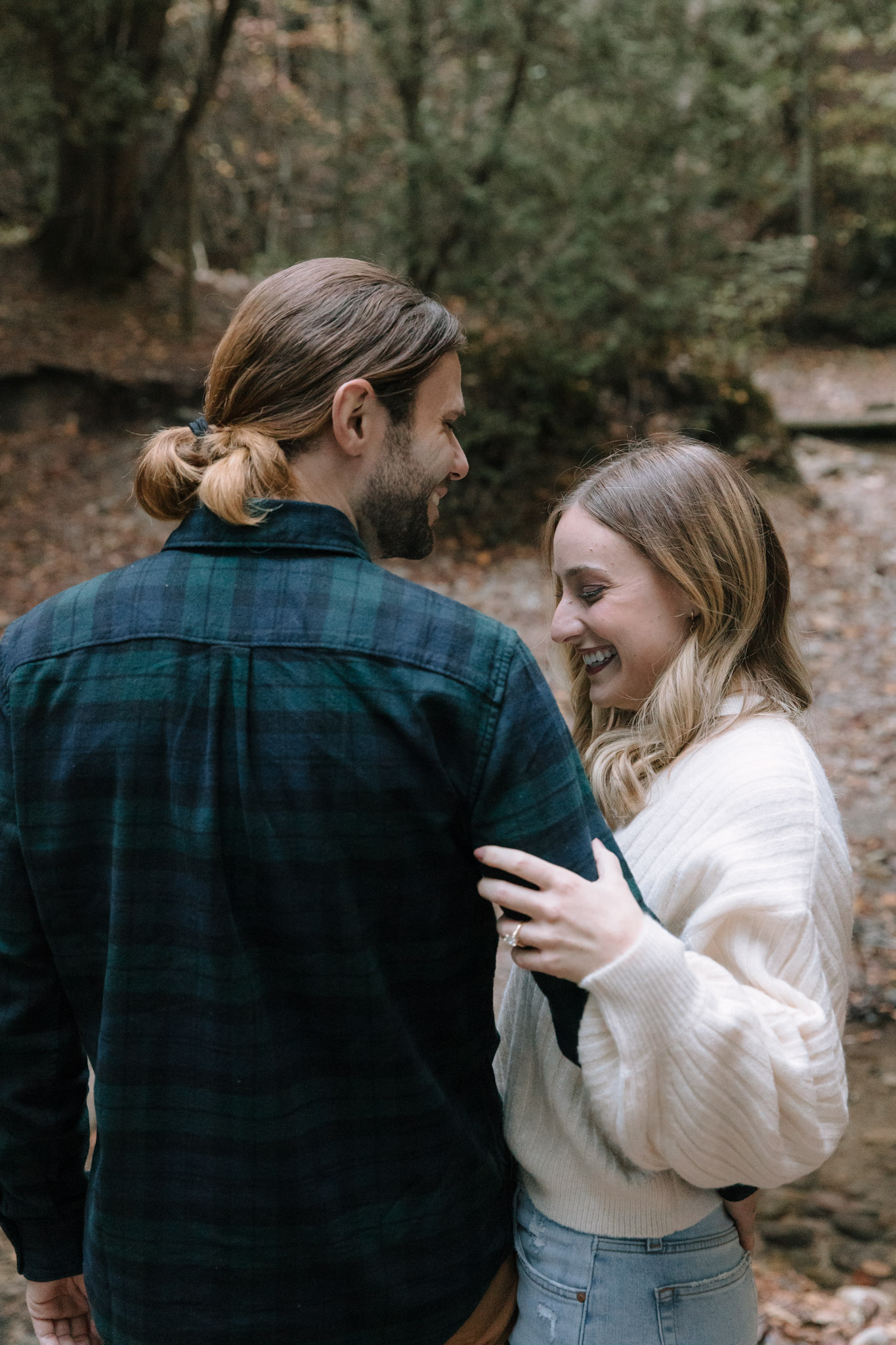 Couple giggling during their engagement session in Port Washington Wisconsin