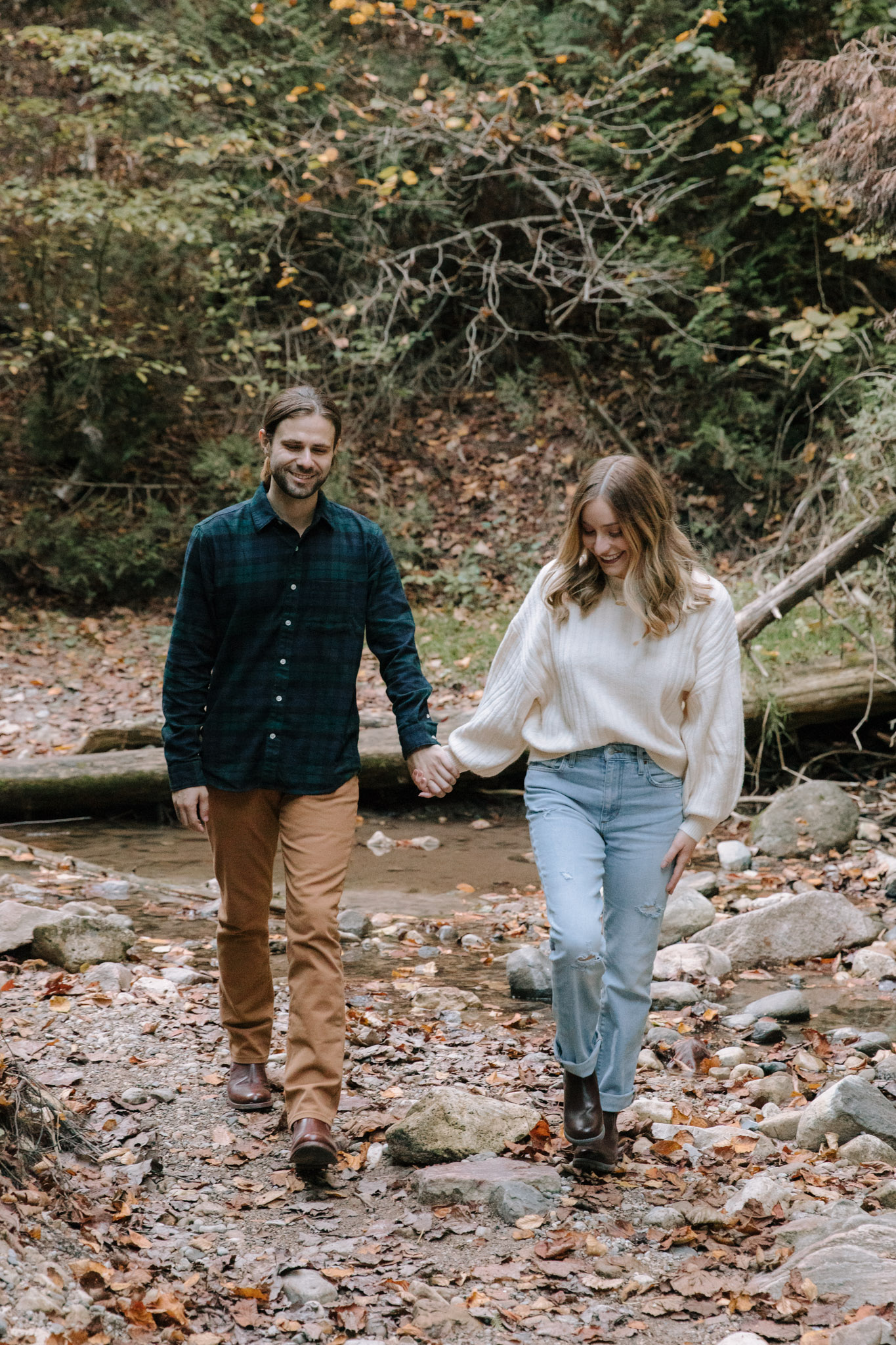 Movement based Wisconsin engagement session - walking hand in hand in the woods