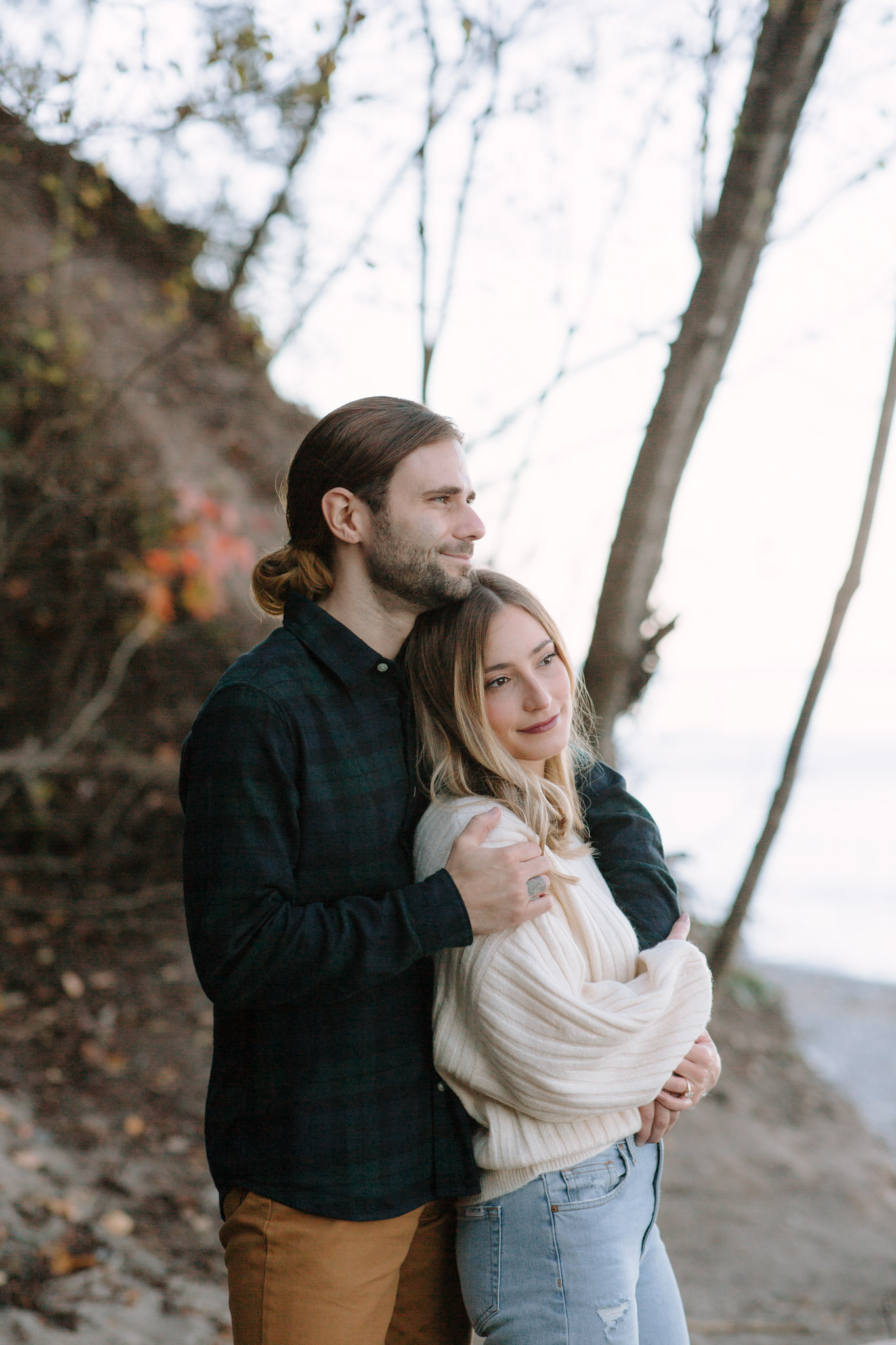 Best couple's engagement outfits: Green plaid shirt with khaki jeans; ribbed cream sweater with distressed light wash jeans