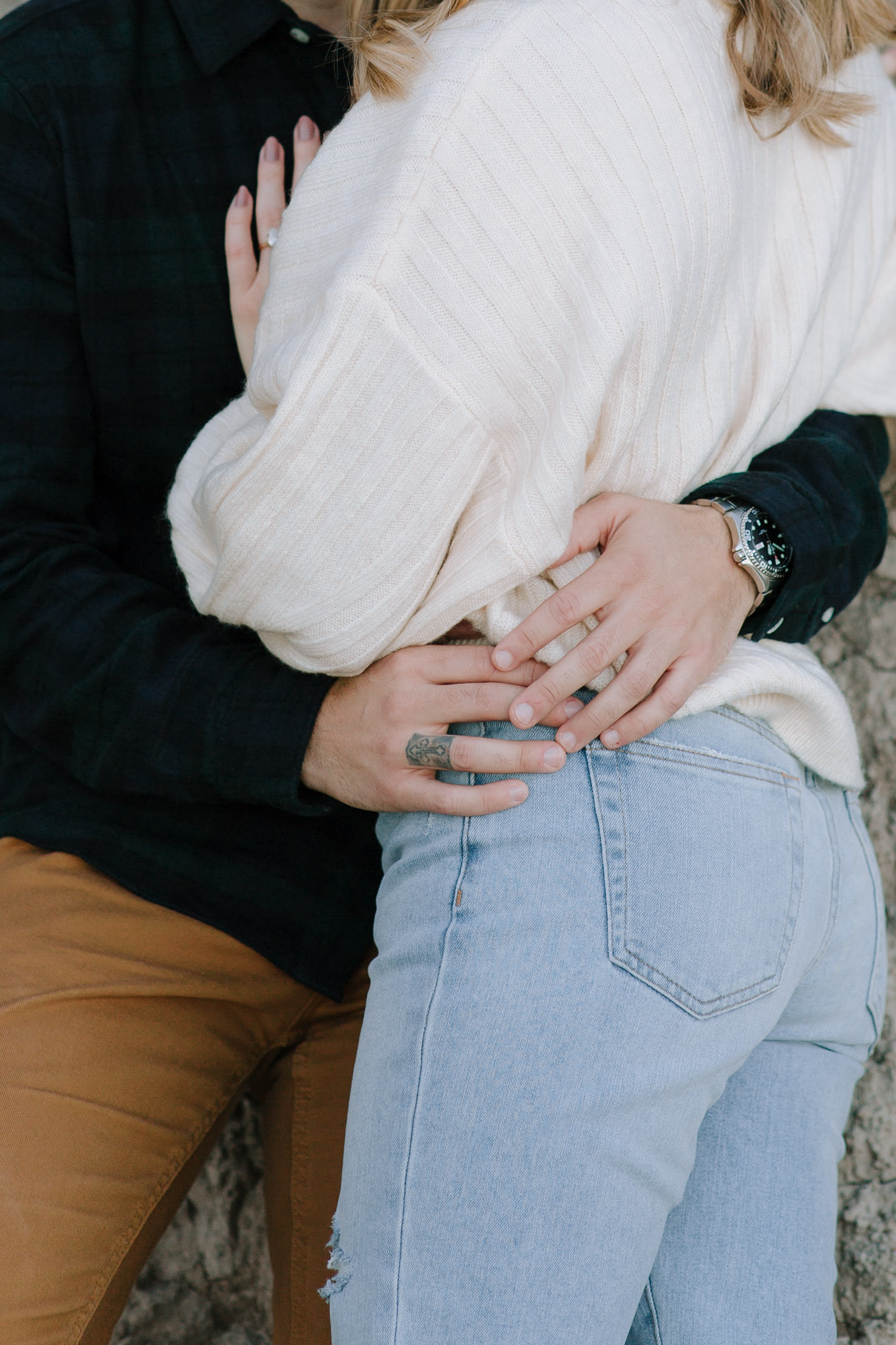 Detail oriented wedding and engagement photographer in Milwaukee, Wisconsin. Close up picture of man's hands on woman's waist