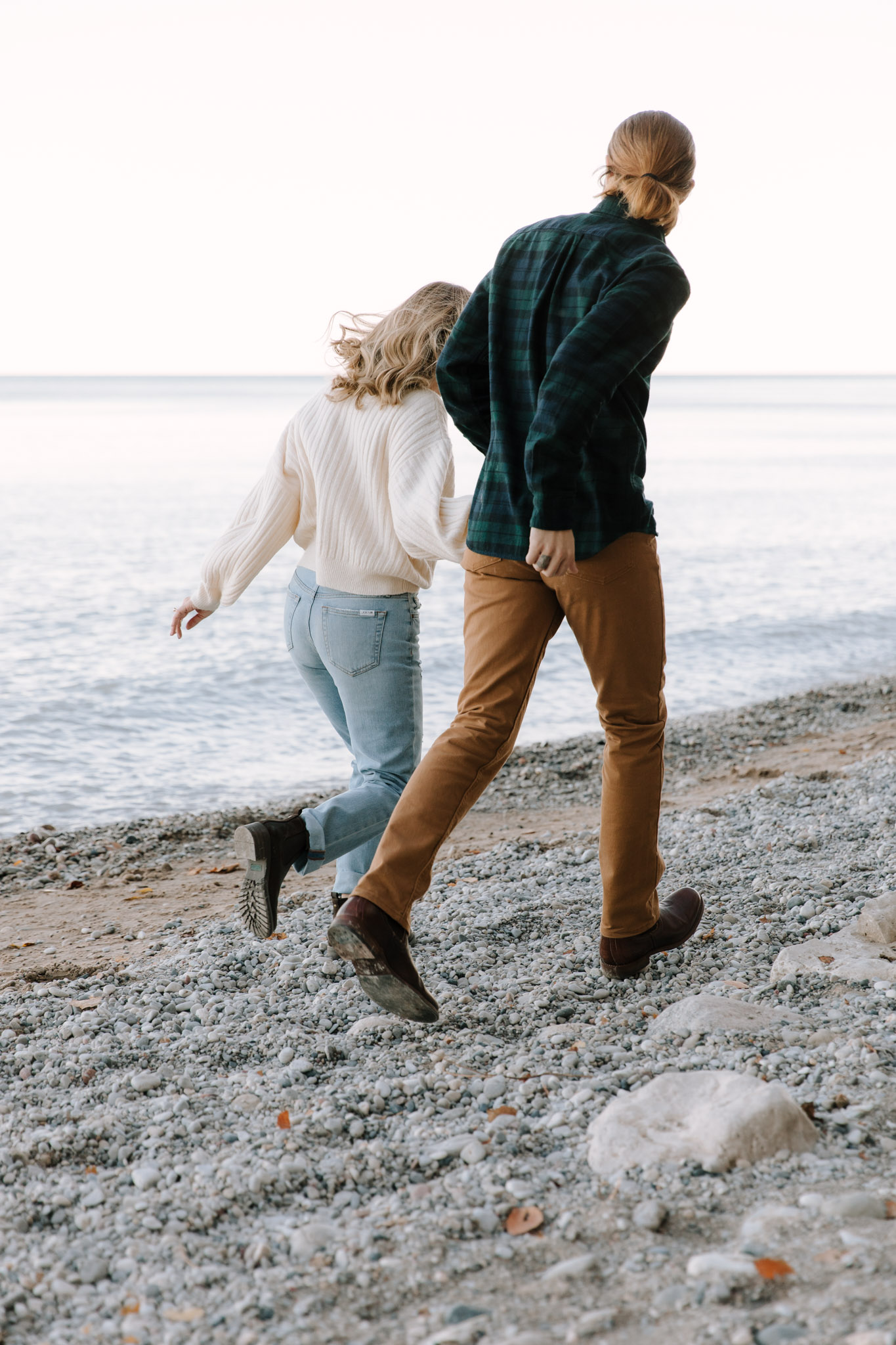 Running along lake michigan - milwaukee wisconsin engagement photographer