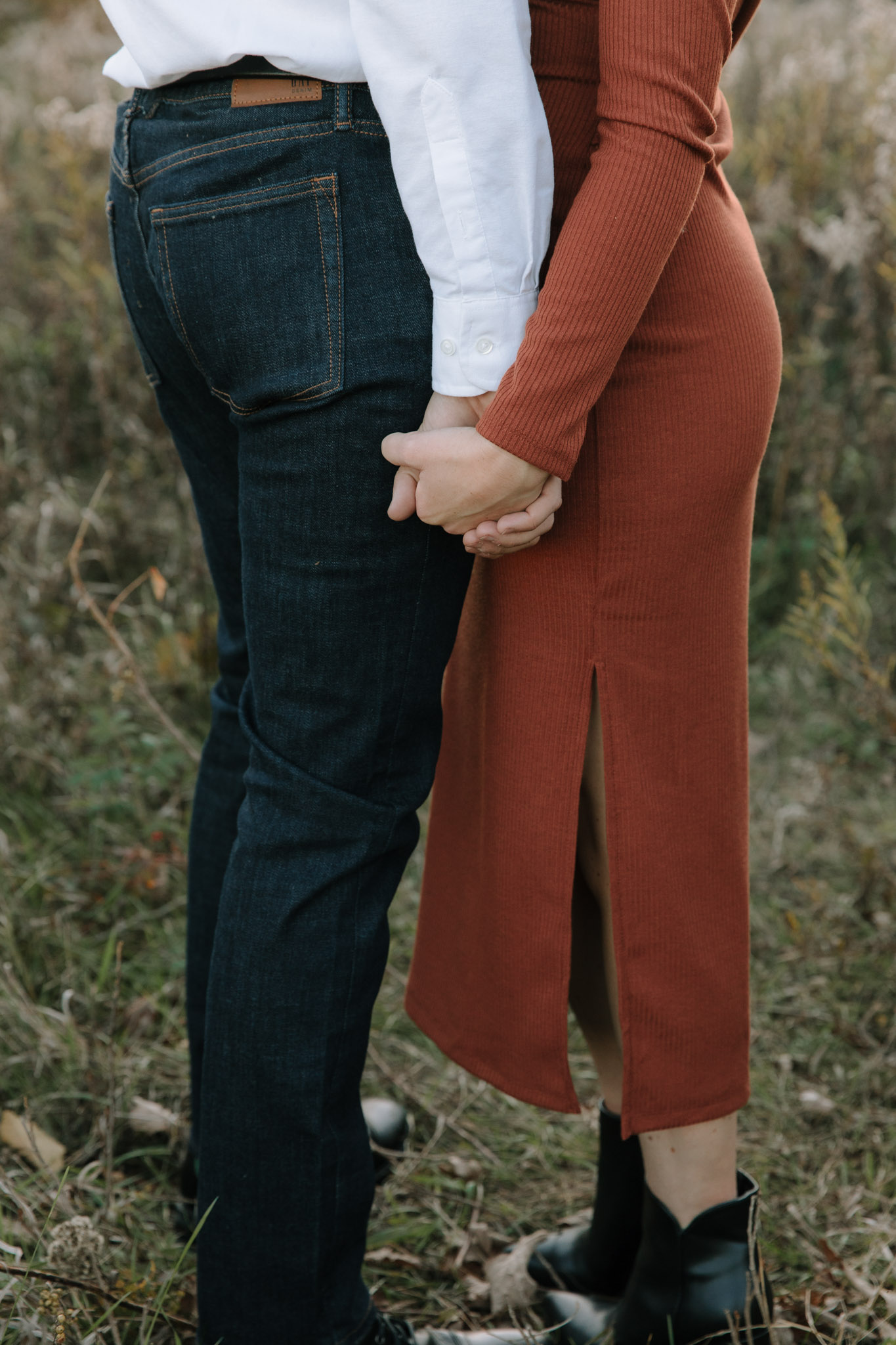 Detail focused engagement pictures - photo of a couple's hand as they stand chest to chest