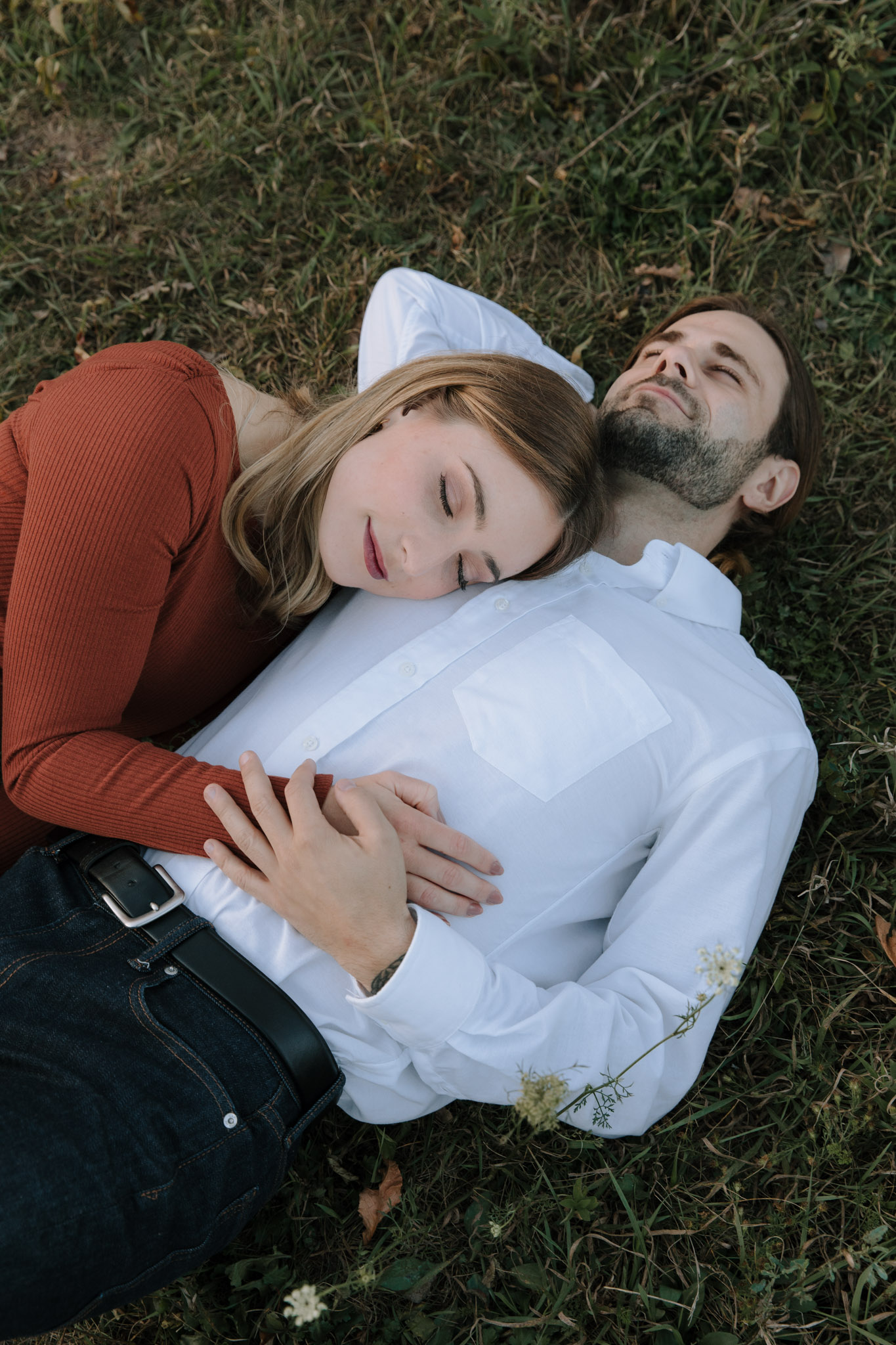 Milwaukee Wisconsin engagement photographer - couple cuddled up and laying in the grass
