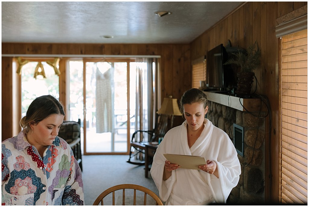 Bride reading letter from belated great grandmother in robe