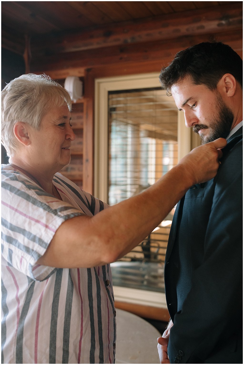 Mother of the groom helping him get ready