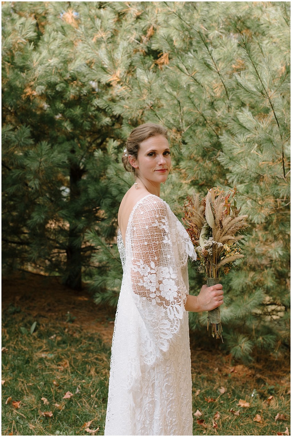 Bride in grace loves lace wedding dress with foraged bouquet -   unique camp wedding inspiration in Northwoods of Wisconsin
