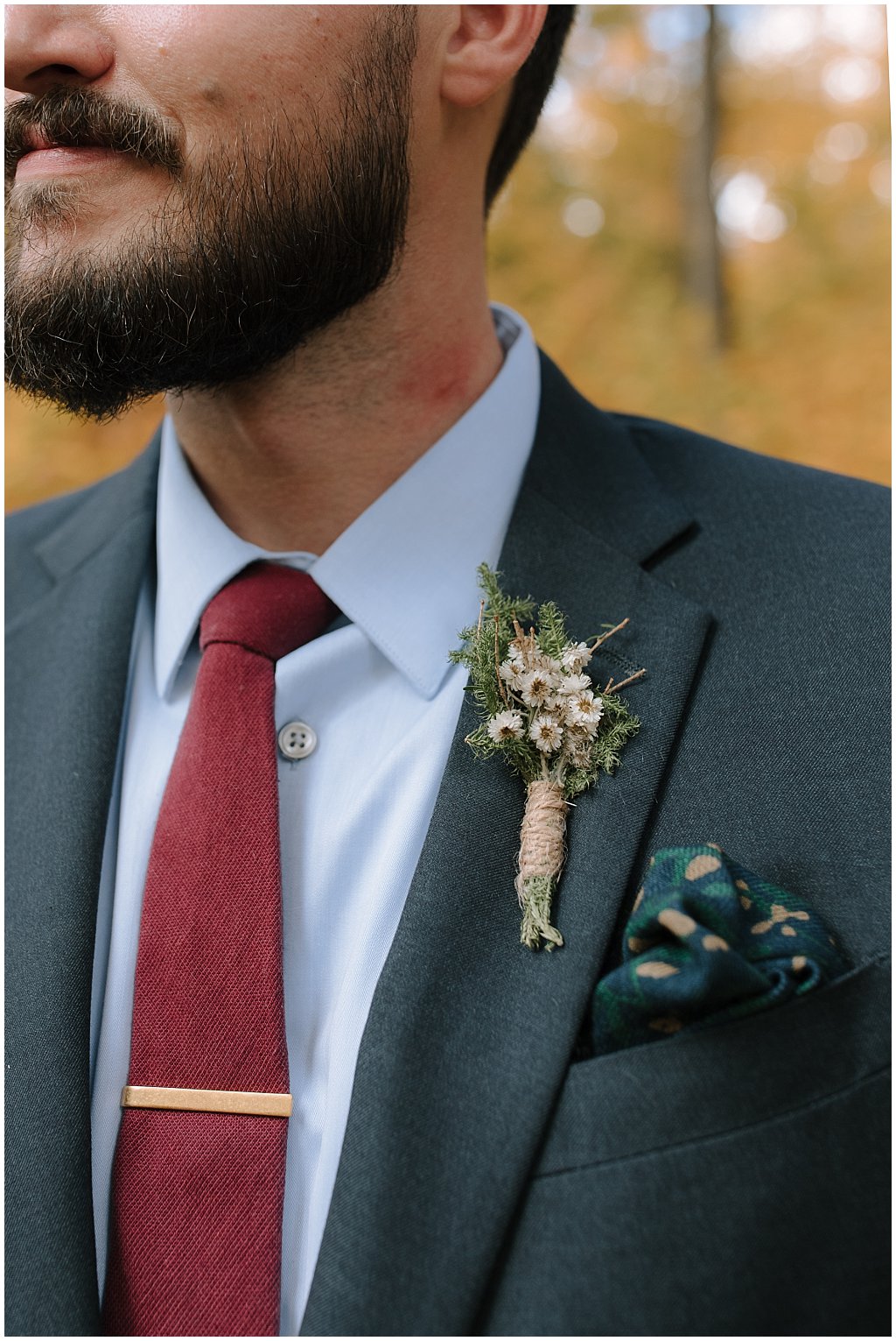 Close up of groom's foraged boutonniere - floral pocket square from j crew - unique camp wedding inspiration in Northwoods of Wisconsin 