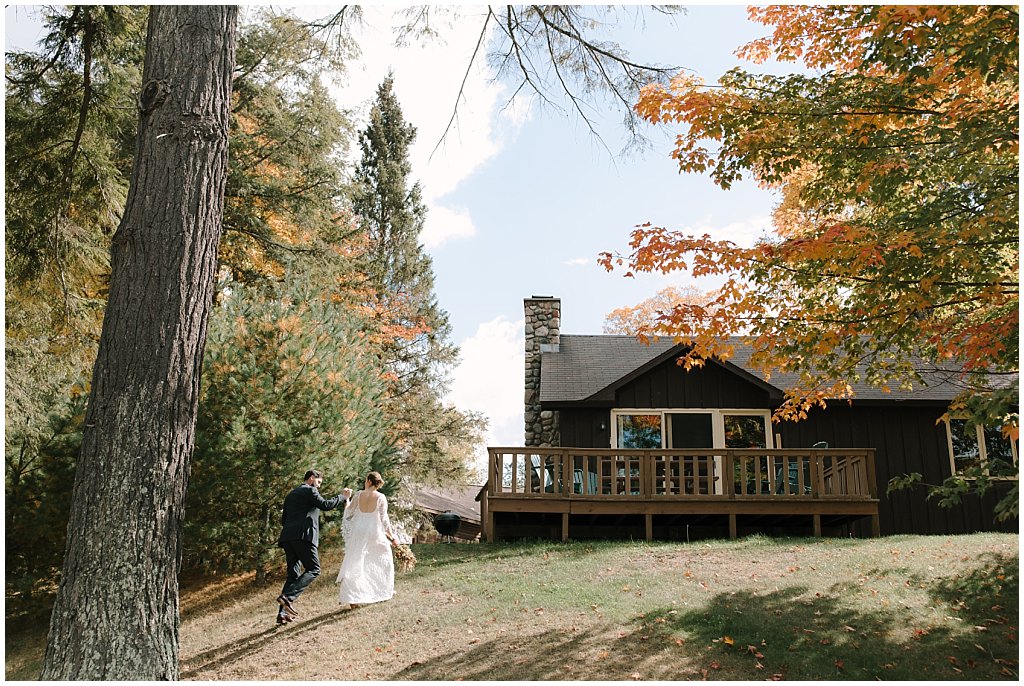 Couples wedding pictures - unique camp wedding inspiration in Northwoods of Wisconsin - Couple walking into cabin