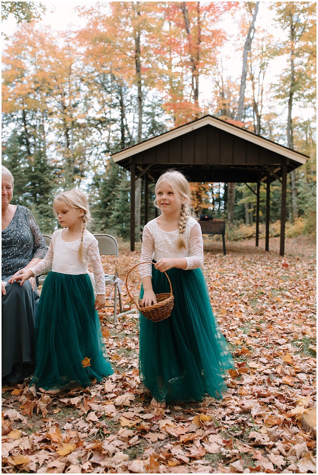 Flower girls throwing leaves - unique camp wedding inspiration in Northwoods of Wisconsin