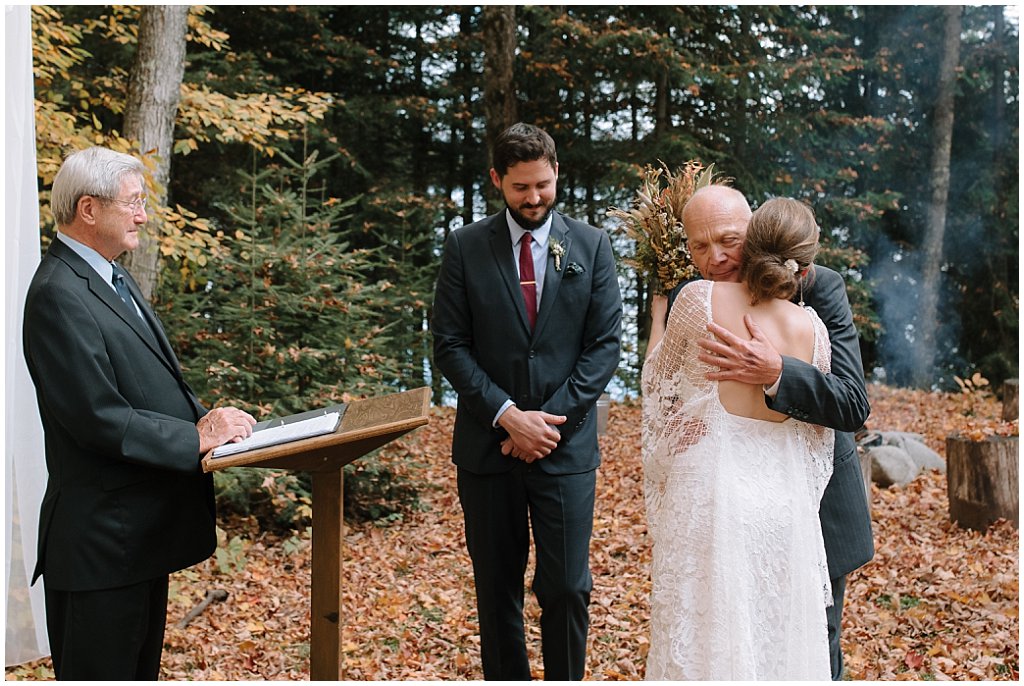 dad hugging bride at ceremony 