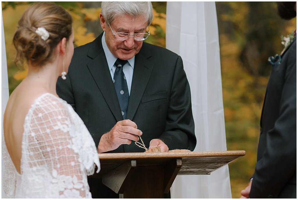 Grandfather giving rings to couple - wedding ceremony -  unique camp wedding inspiration 