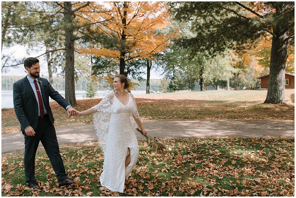 Bride in grace loves lace dress with foraged bouquet - fall camp wedding inspiration
