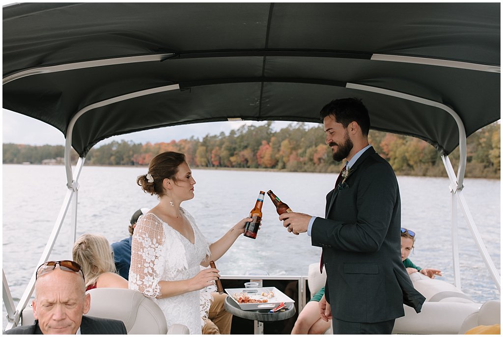 boat cocktail hour booze cruise - unique camp wedding inspiration in Northwoods of Wisconsin on lake with boat