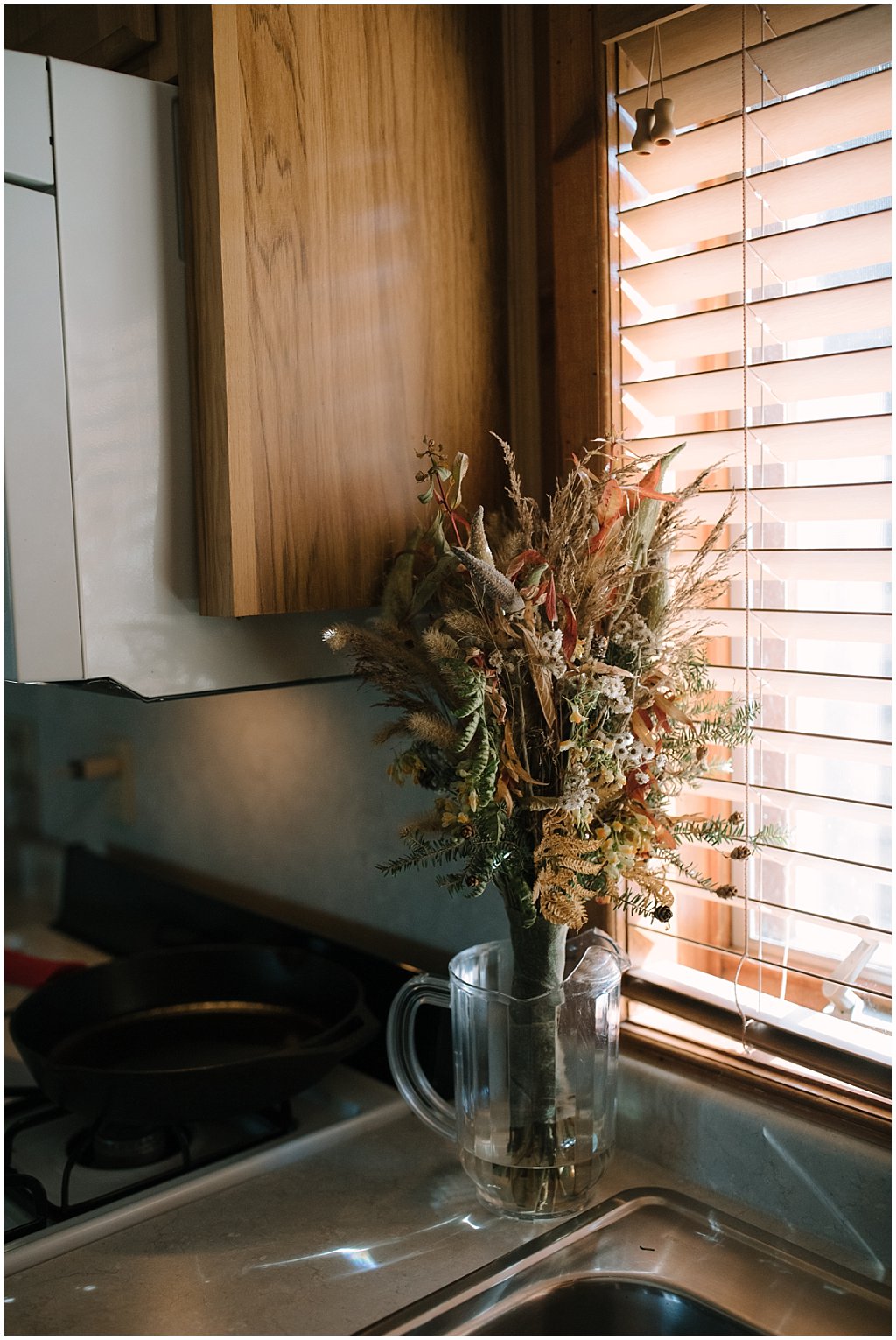 Foraged wedding bouquet in glass pitcher in cabin - unique camp wedding inspiration in wisconsin northwoods
