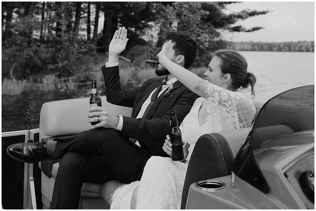 boat cocktail hour booze cruise - unique camp wedding inspiration in Northwoods of Wisconsin on lake with boat