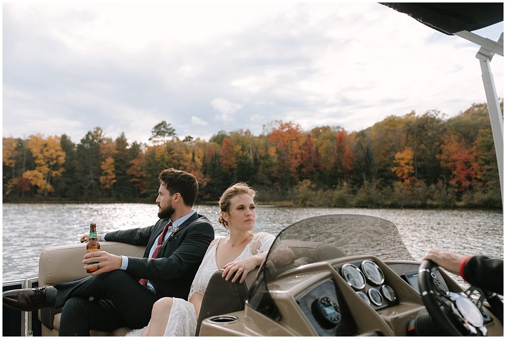 boat cocktail hour booze cruise - unique camp wedding inspiration in Northwoods of Wisconsin on lake with boat