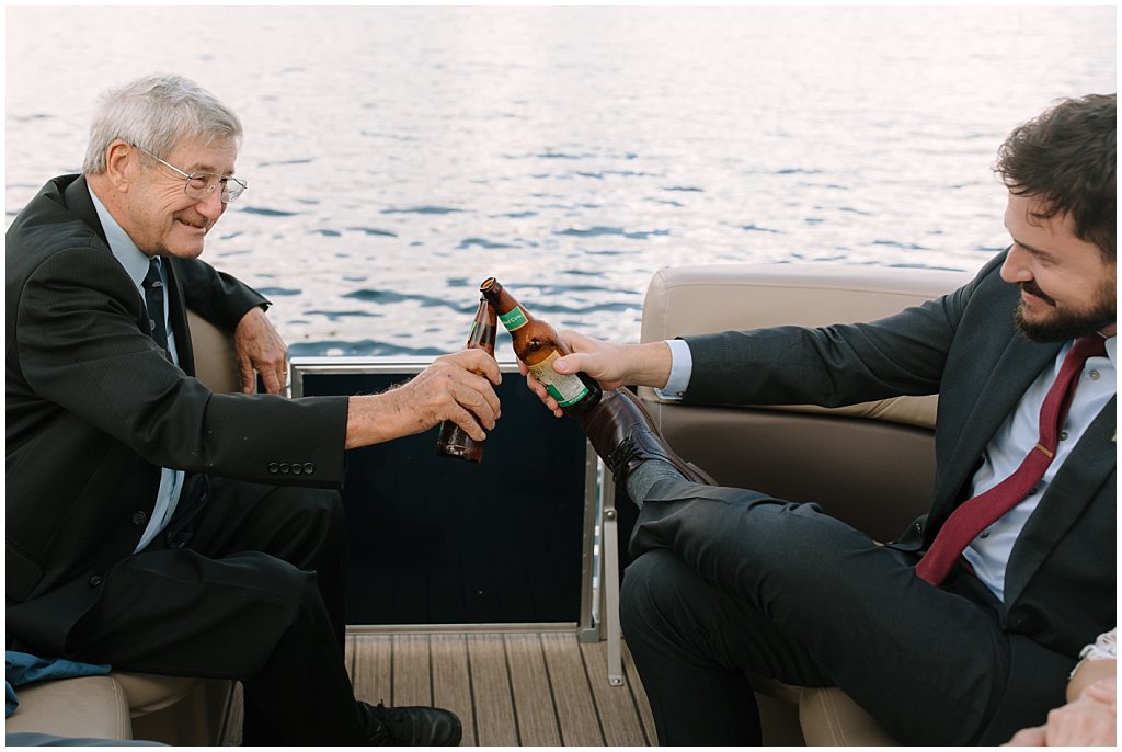 boat cocktail hour booze cruise - unique camp wedding inspiration in Northwoods of Wisconsin on lake with boat