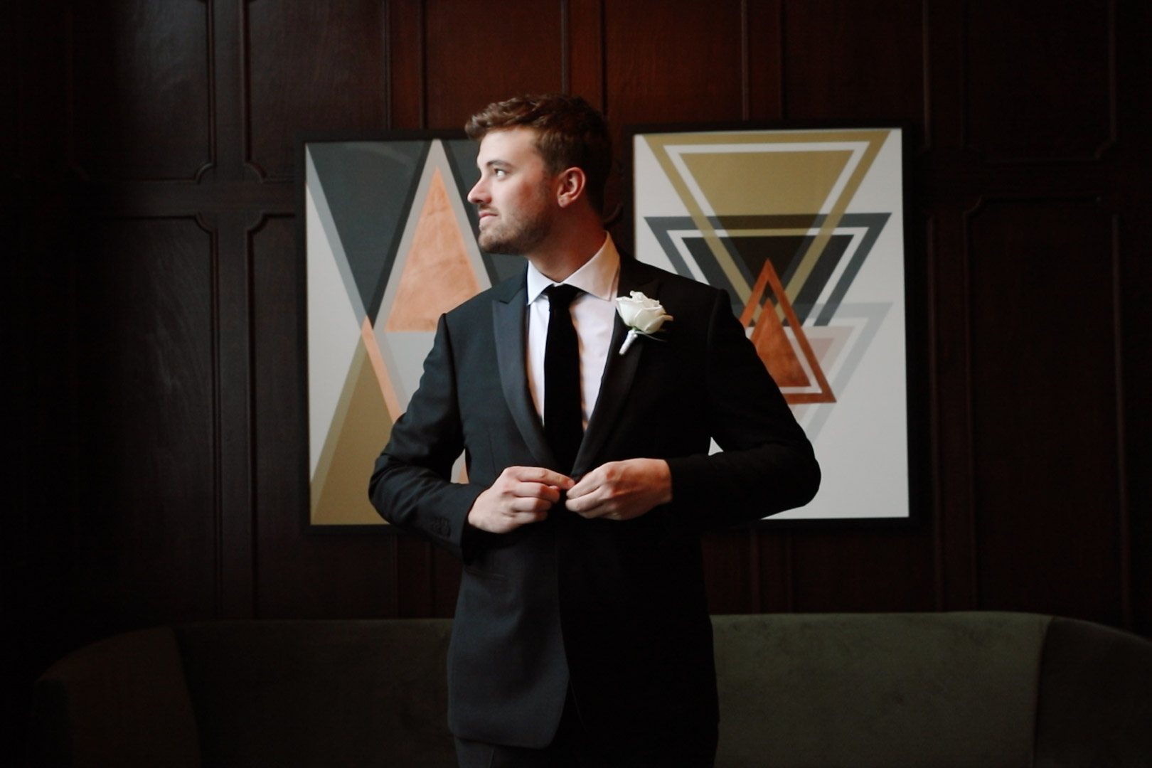 Groom in classic black suit and velvet tie at art deco hotel Green Bay