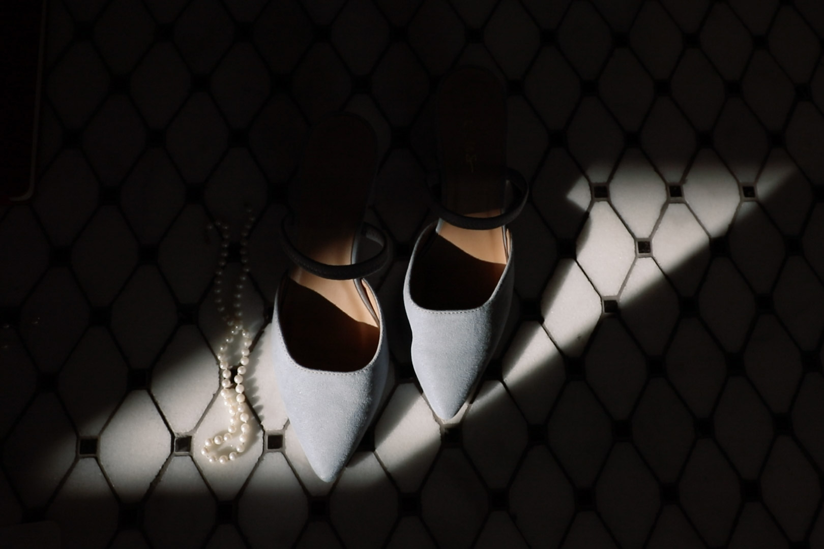 Blue wedding shoes and grandmother's pearl on textured tiled floor - How to get your wedding published