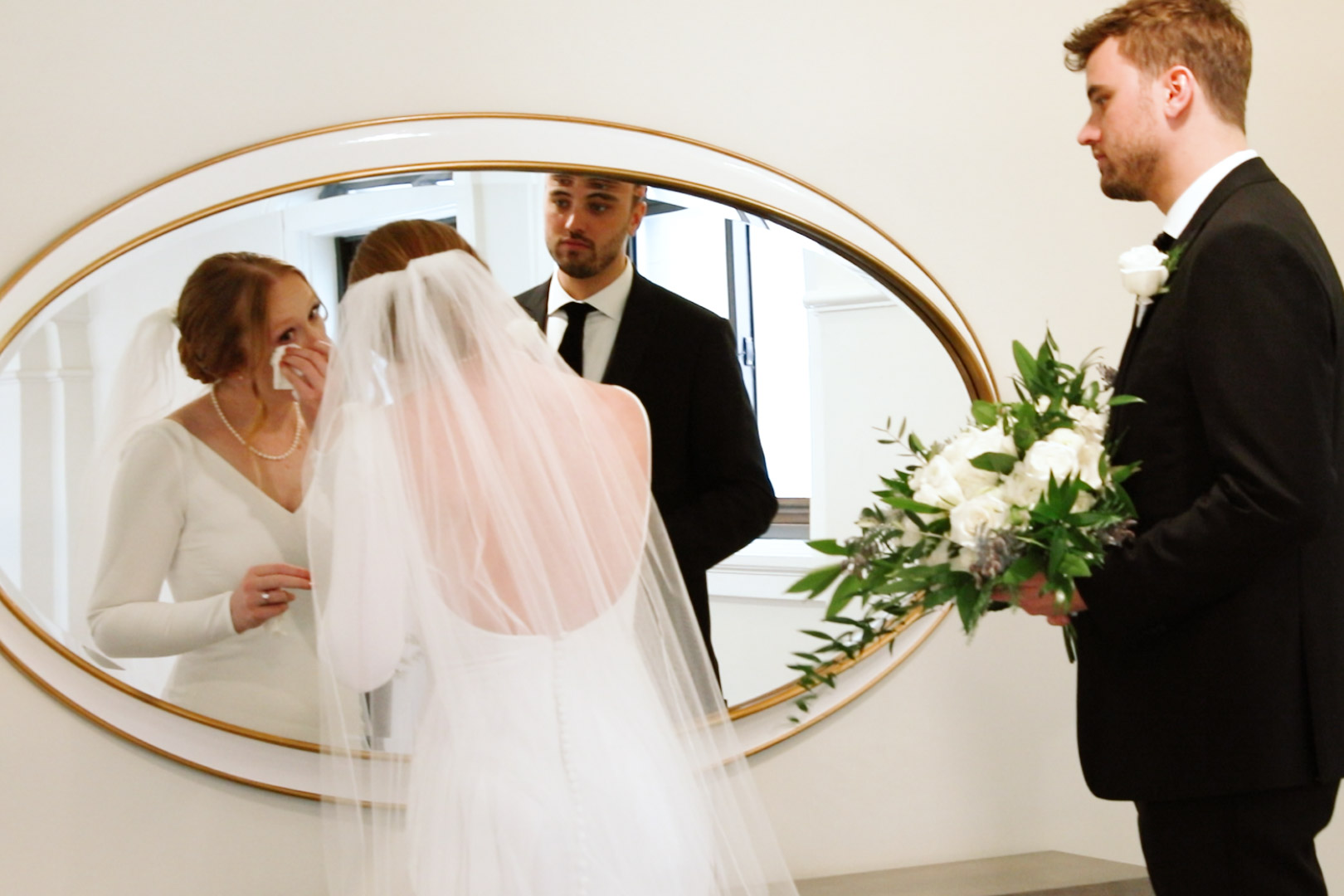 Bride and groom after their wedding ceremony at Hotel Northland in front of an art deco mirror