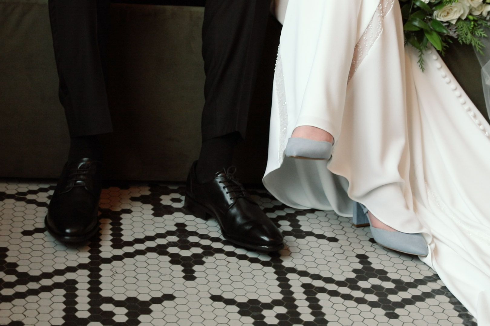 Wedding shoes and art deco tile with green couch at Hotel Northland in Green Bay