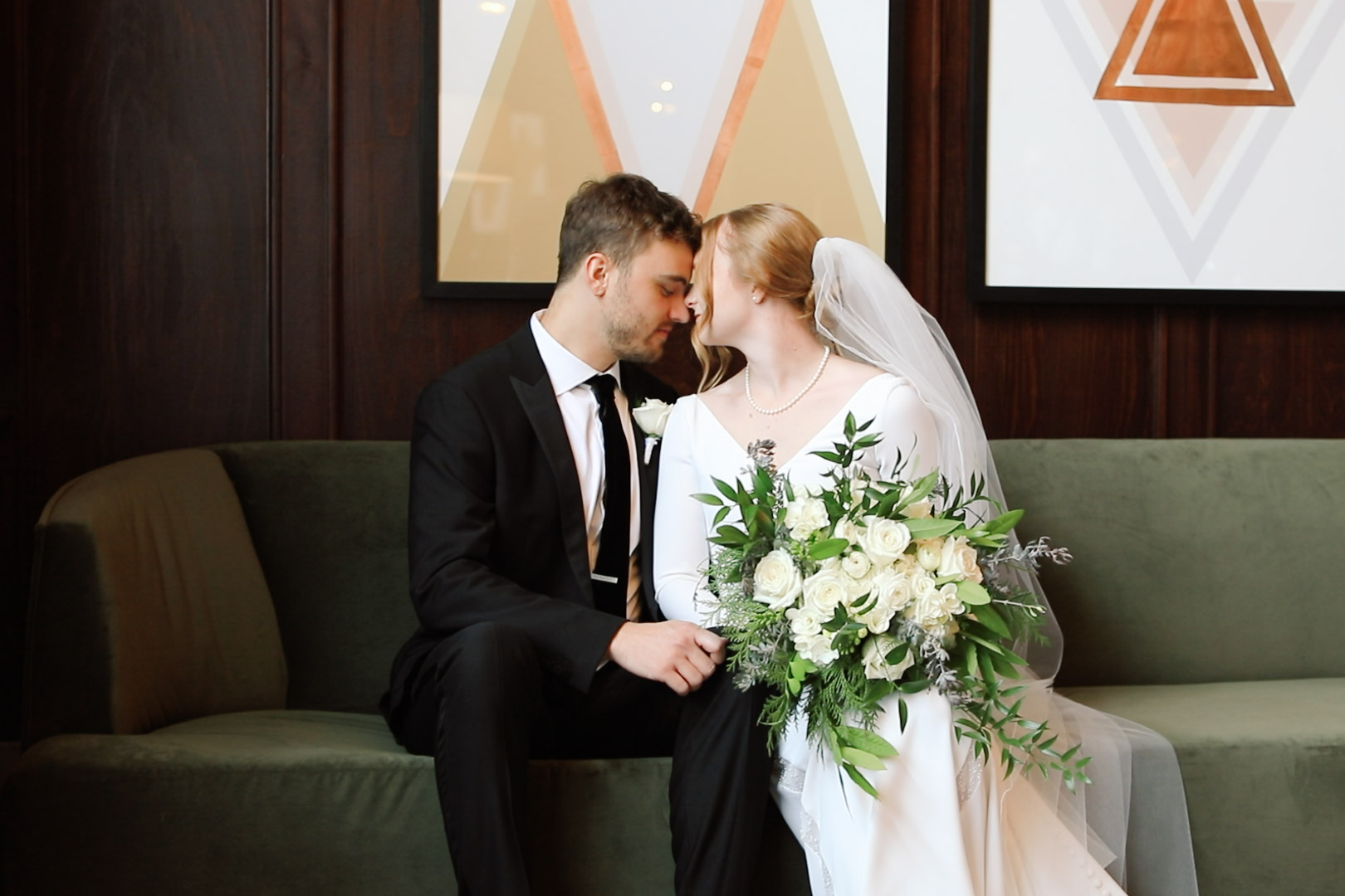Couple sitting on the couch in the lobby of Hotel Northland before their wedding